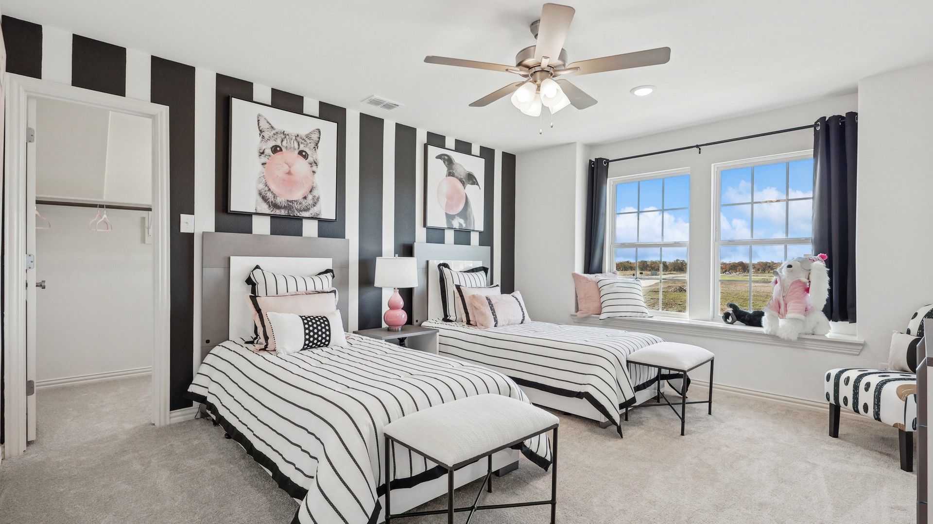 Twin bedroom boasts chic stripes, plush carpet, and artistic flair, epitomizing luxury in Bel Air Village.