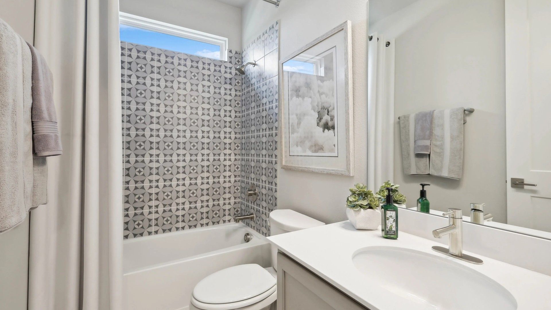 Refined geometric tile enhances this Hulen Trails bathroom's modern elegance and sophisticated design.
