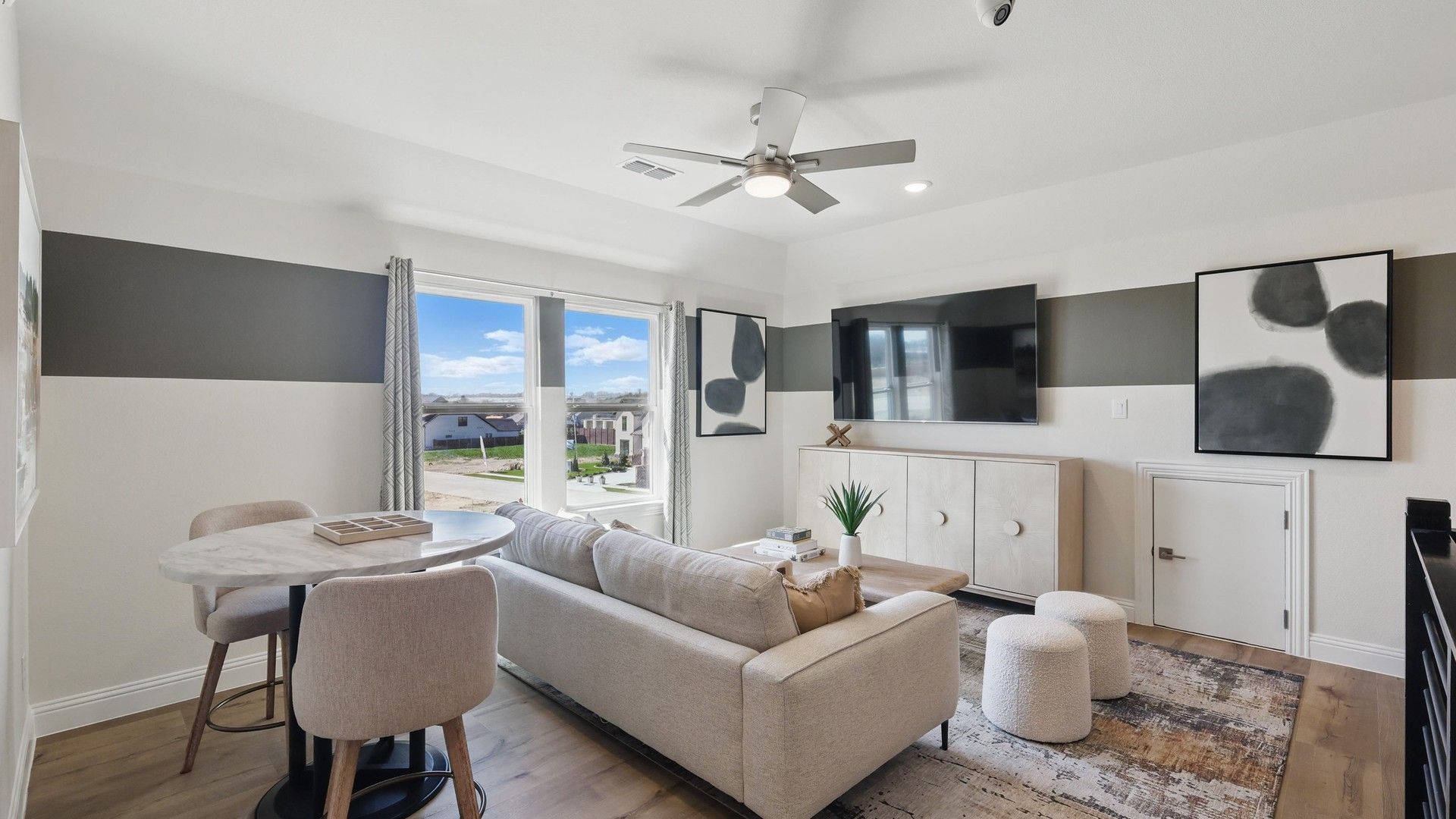 Elegant living area with marble accents and abstract art. Located in Rio Vista at Kelly Ranch.