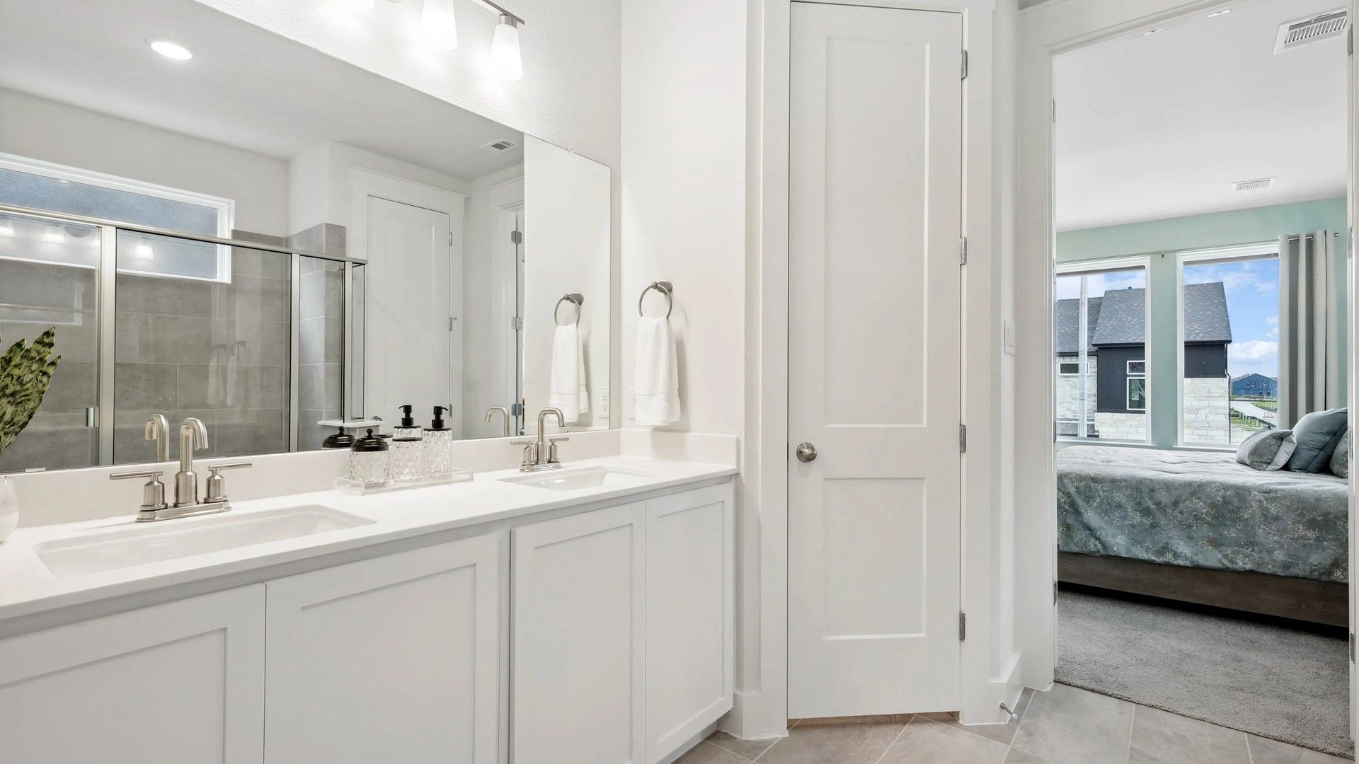 Experience refined luxury with dual sinks, chic cabinetry, and sleek fixtures in Collin Creek's elegant bathroom.