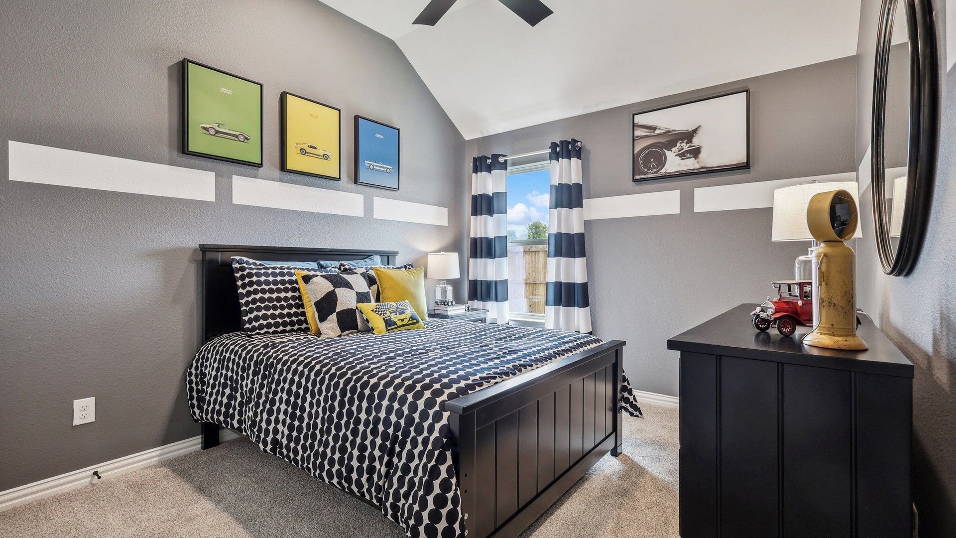 Elegantly designed bedroom with a vaulted ceiling in Churchill. Stylish decor and bold color accents.