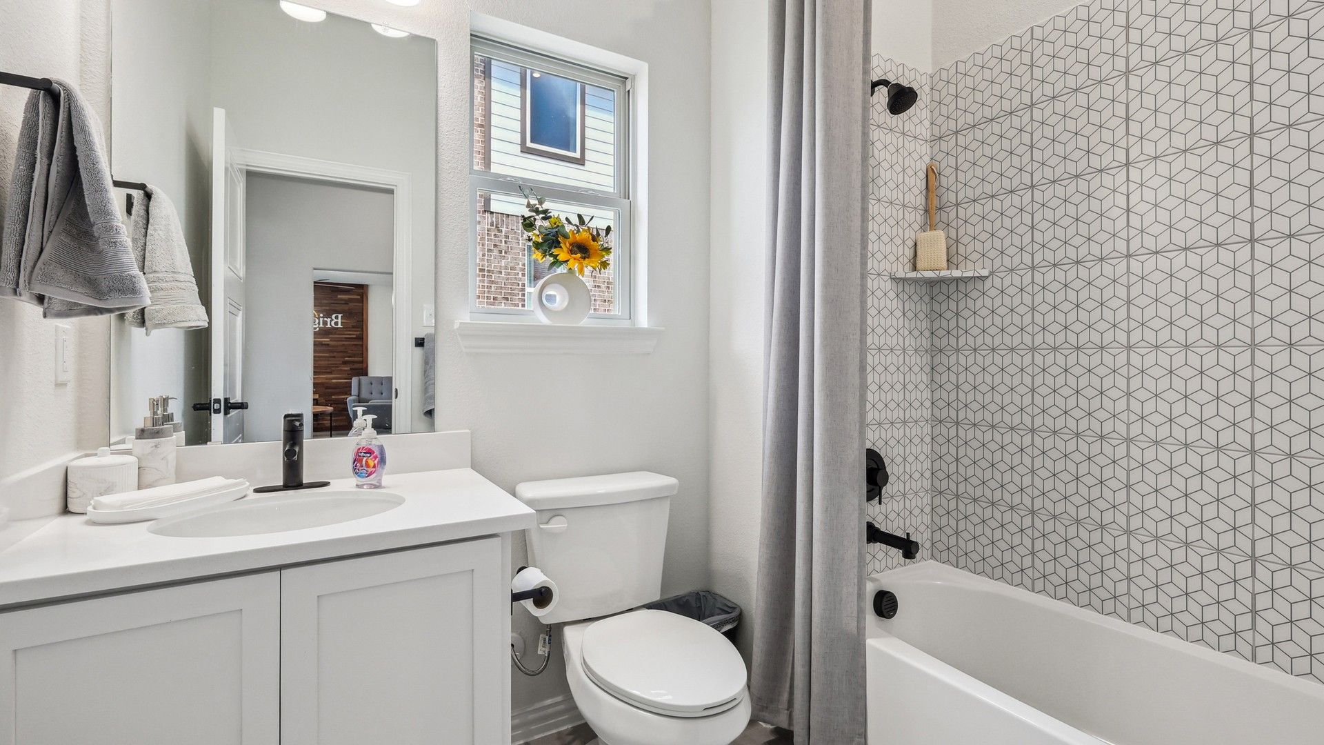 Geometric tile backsplash and sleek fixtures exemplify modern luxury in this Churchill community bathroom.