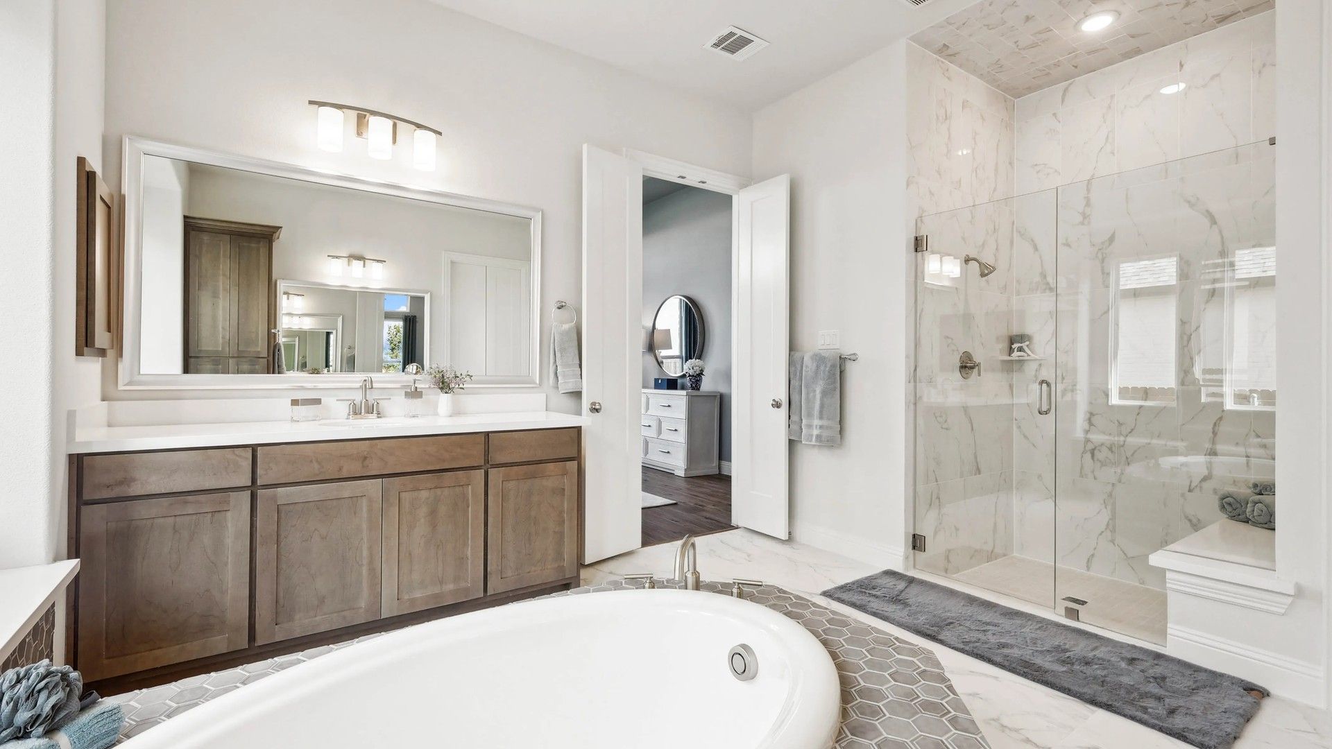 Experience opulence with a marble shower, freestanding tub, and bespoke vanity in Ridge Crossing.