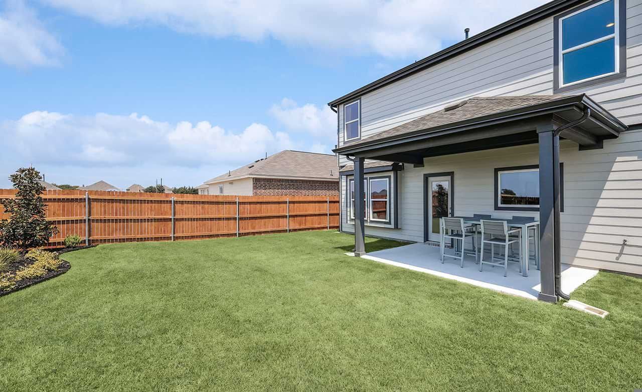 Experience luxury with a covered patio opening to a lush lawn in Walden Pond. Tranquil outdoor living.