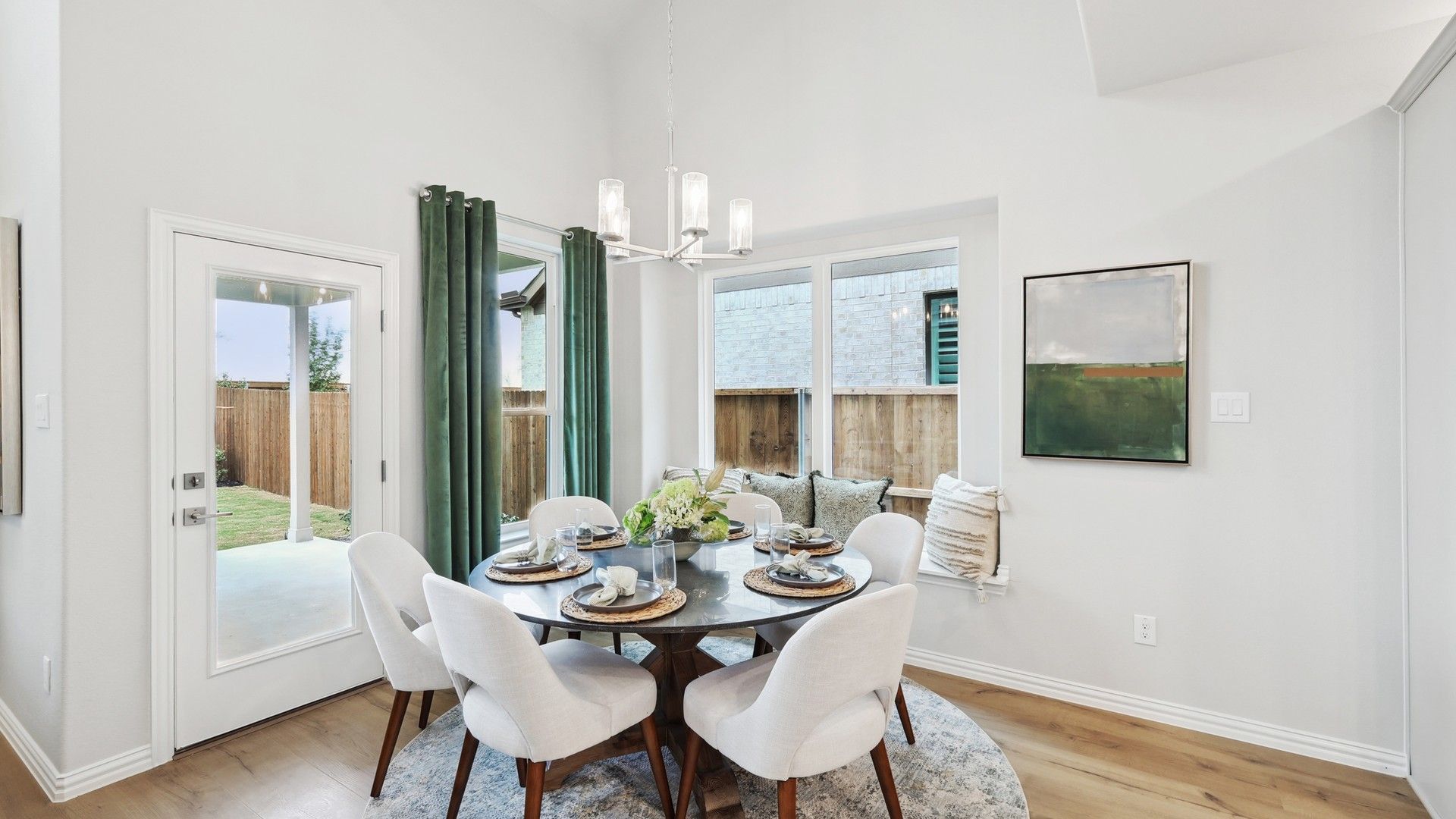 Luxurious dining room featuring a modern chandelier and plush seating in Wildflower Ranch, Texas.