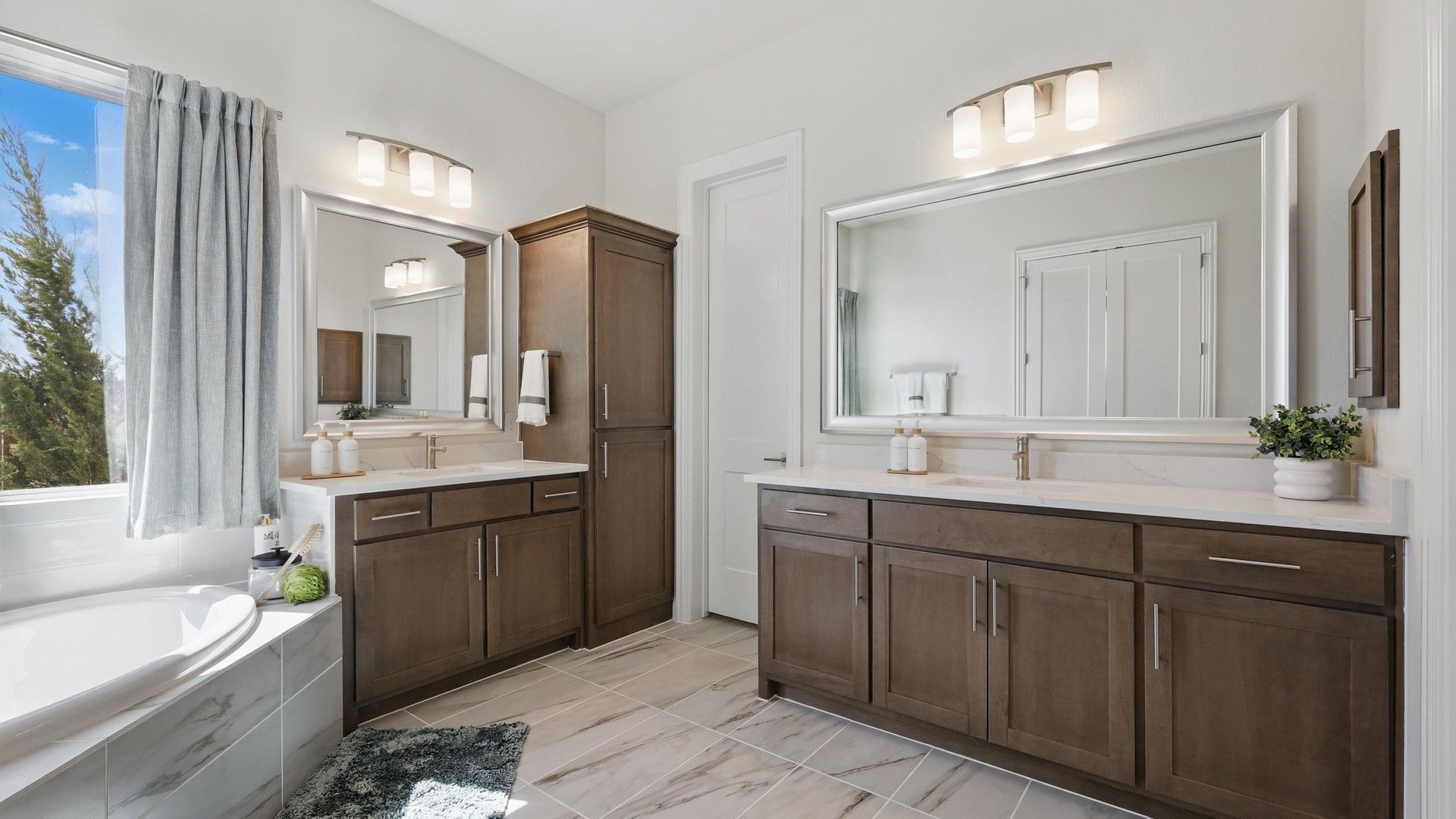 Experience bespoke design with dual sinks, sophisticated cabinetry, and exquisite marble tile at Rio Vista, Kelly Ranch.