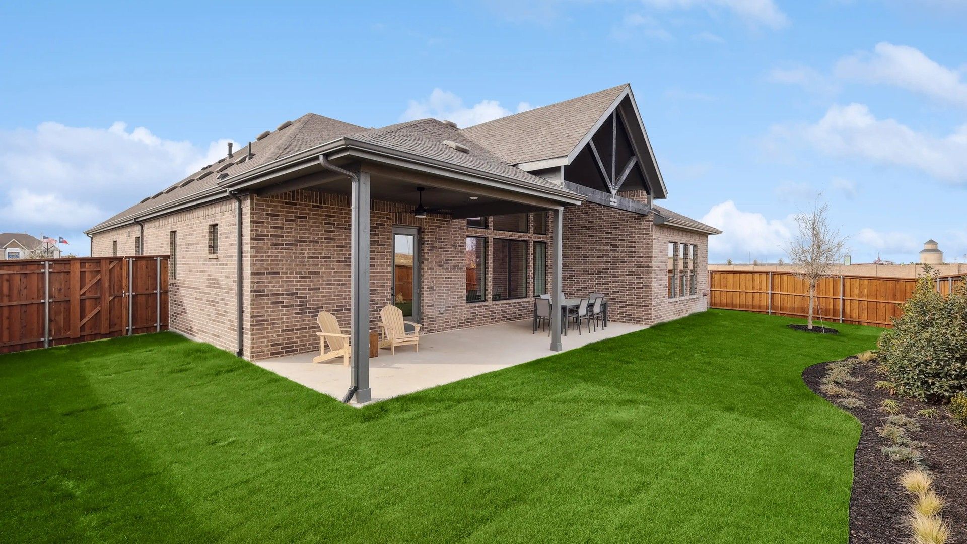 Sophisticated brick architecture with expansive patio in Westside Preserve, perfect for tranquil suburban living.