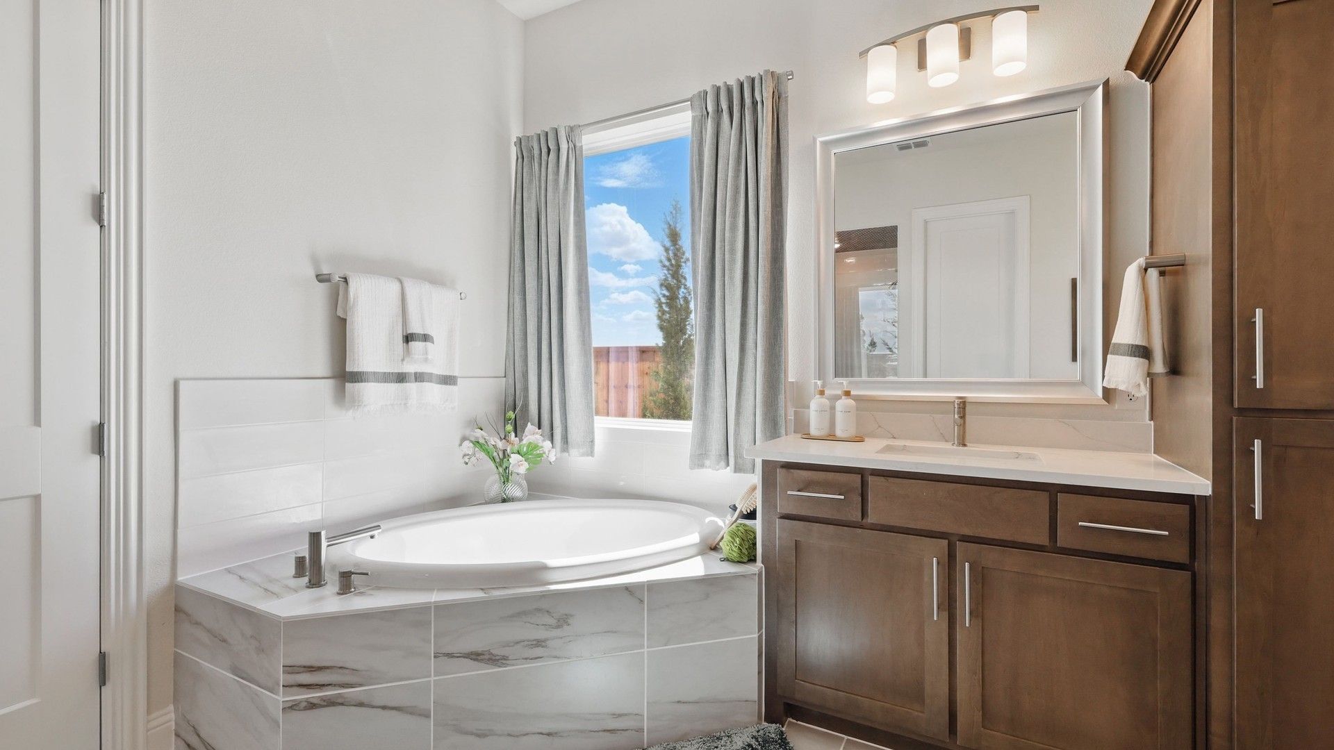Experience luxury with sleek marble tiles and rich wood cabinetry in Rio Vista at Kelly Ranch.