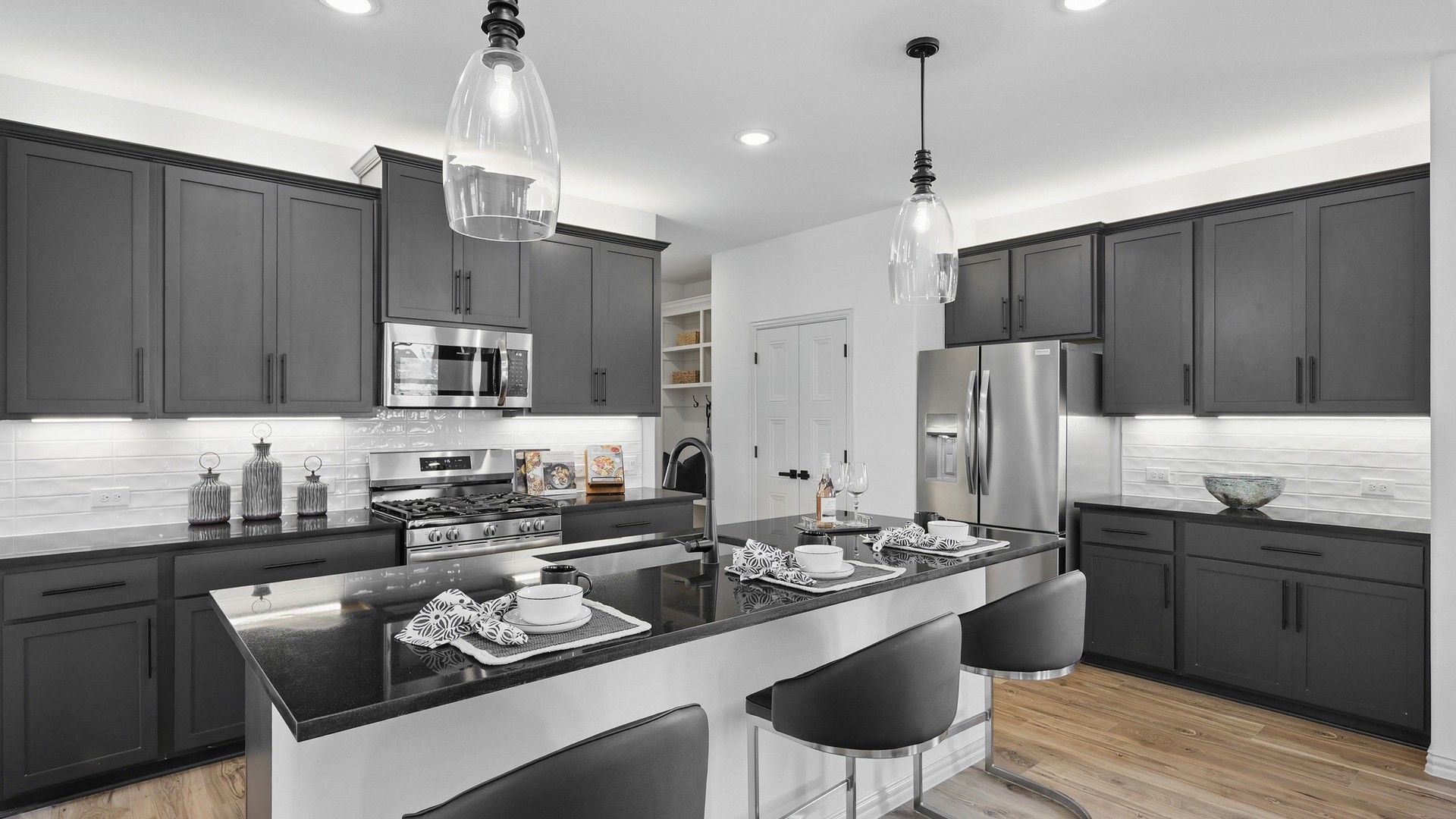 Sleek dark cabinetry and granite countertops highlight this stylish Westridge kitchen masterpiece.