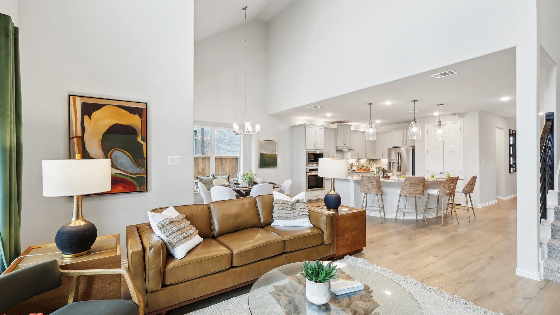 Luxurious vaulted ceilings and chic interiors grace this Wildflower Ranch home, enhancing elegance.