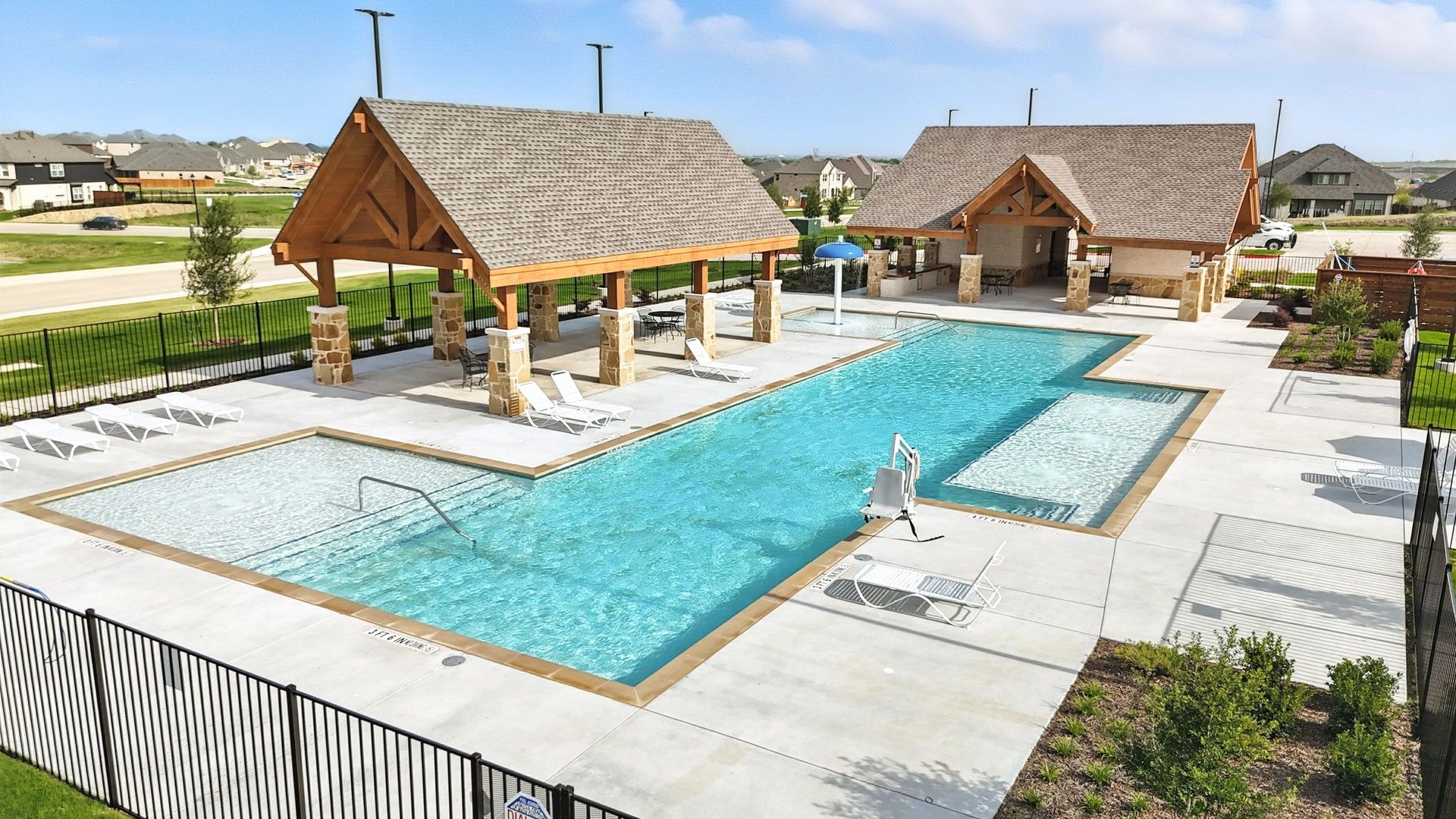 Experience elegant living with a chic pool, stone columns, and wood beam cabanas at Westside Preserve.