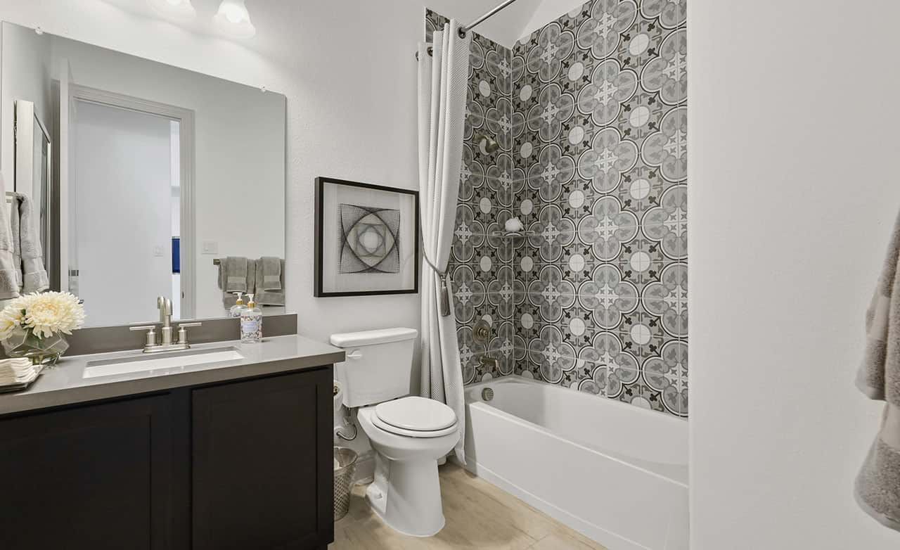 Luxurious bathroom featuring exquisite patterned tiles and modern fixtures in Thompson Farms.