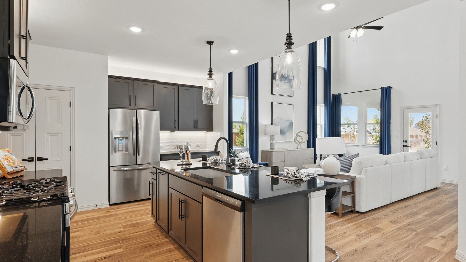 Sleek black kitchen island and soaring double-height ceiling embody sophistication in Westridge.