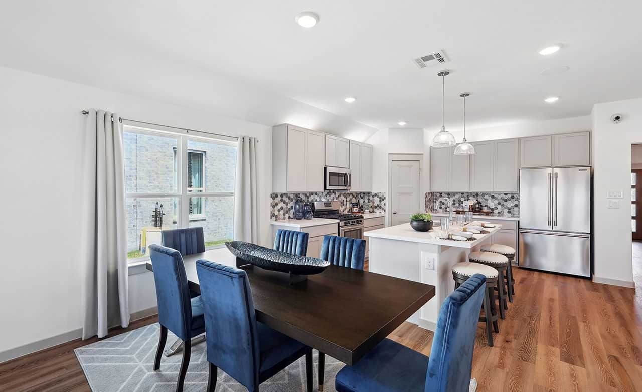 Exquisite kitchen with premium appliances and rich wood flooring. Elegant dining setup enhances Walden Pond living.