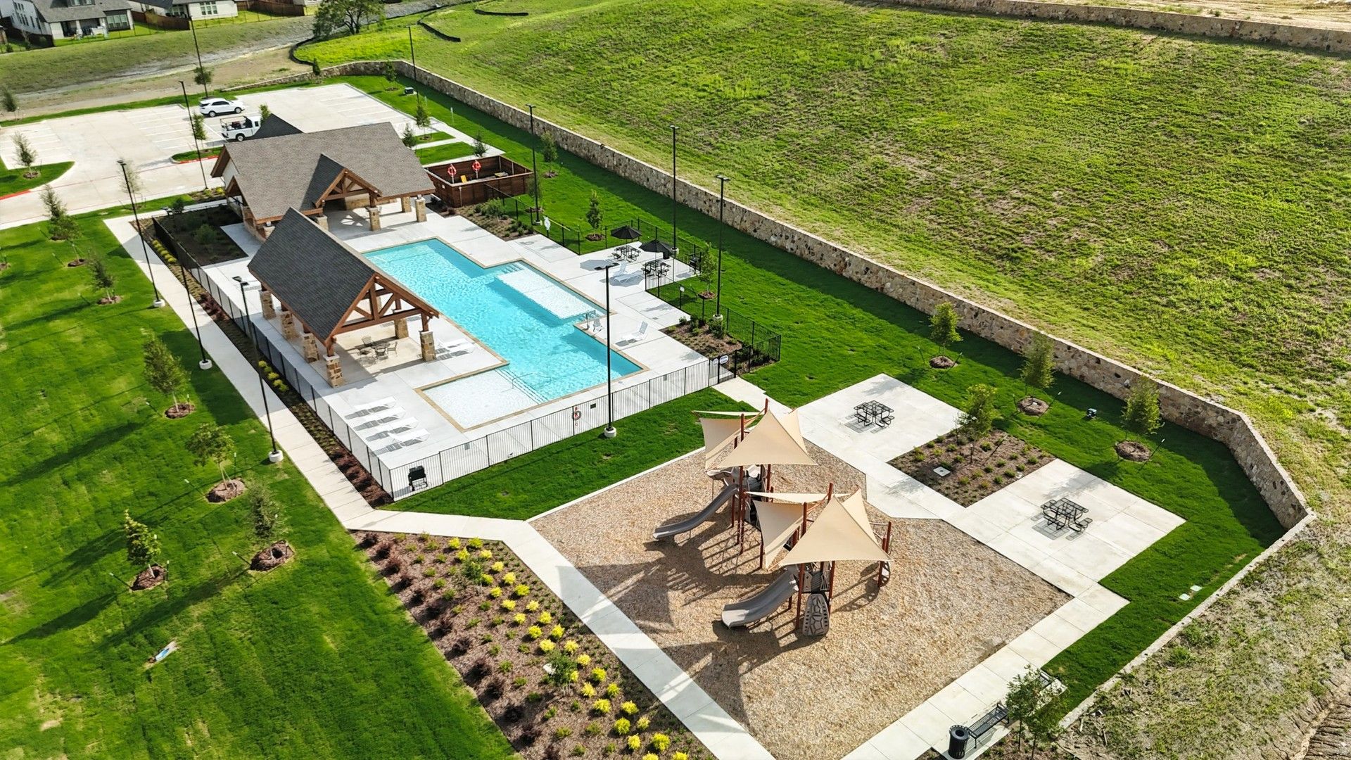 Westside Preserve features a rustic stone pavilion, resort-style pool, and modern playground for luxury family living.