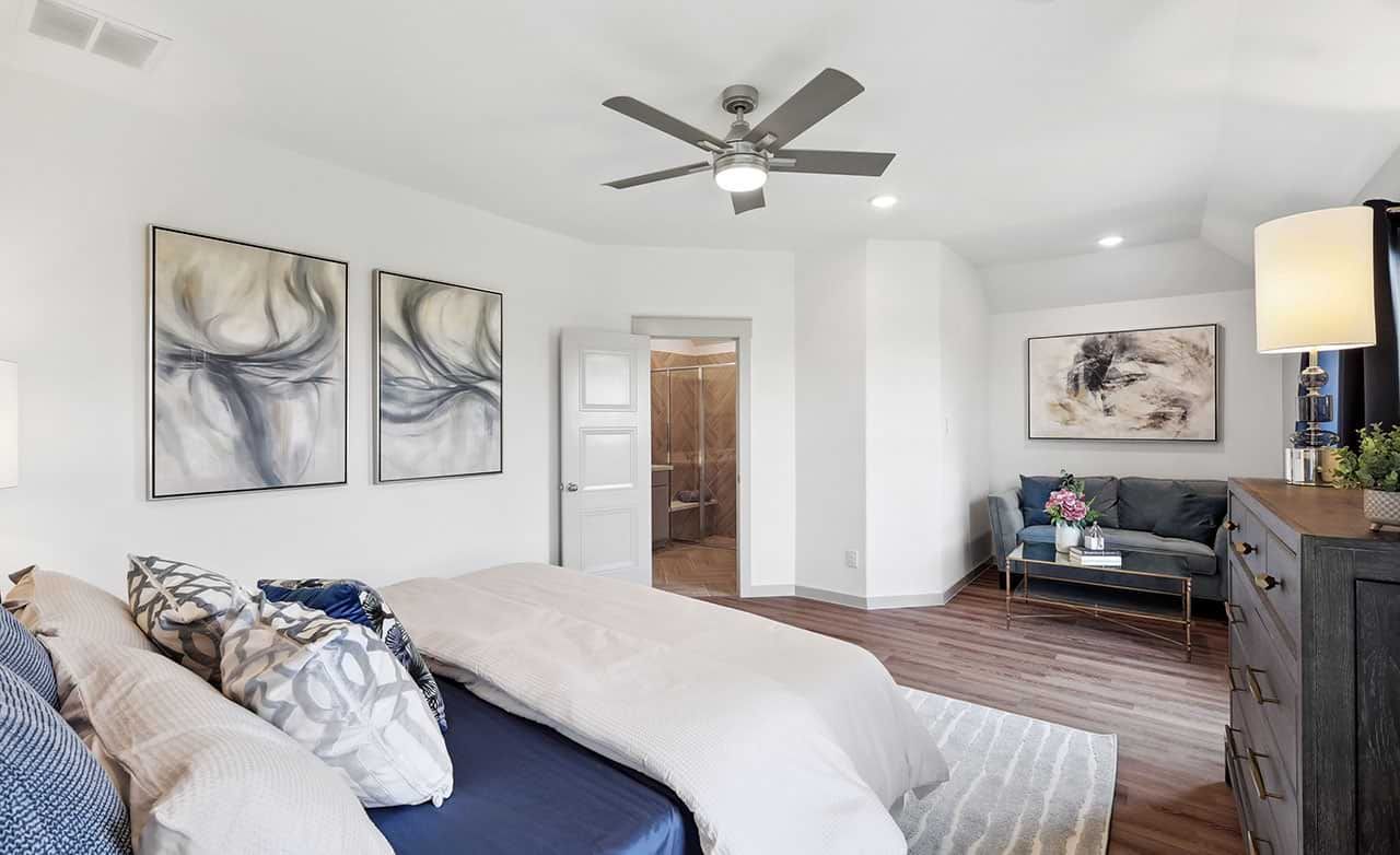Luxurious bedroom featuring abstract art, rich hardwood floors, and modern ceiling fan in Walden Pond.