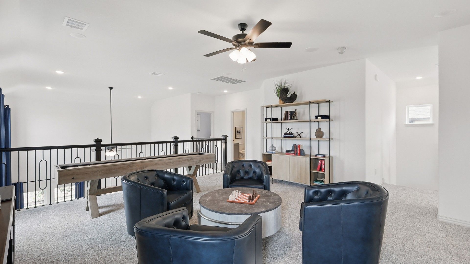 Sophisticated loft with plush seating, artistic shelving, and elegant railing in Westridge, Texas.