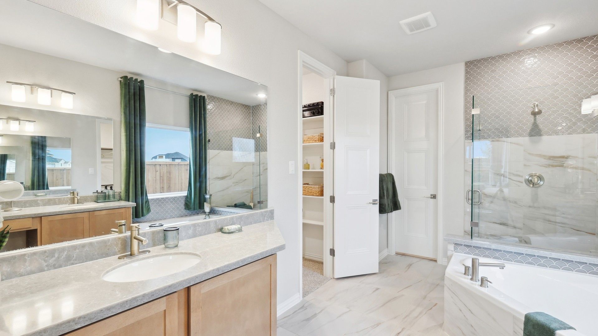 Opulent marble tiles and elegant fixtures elevate this Wildflower Ranch bathroom to unmatched luxury.