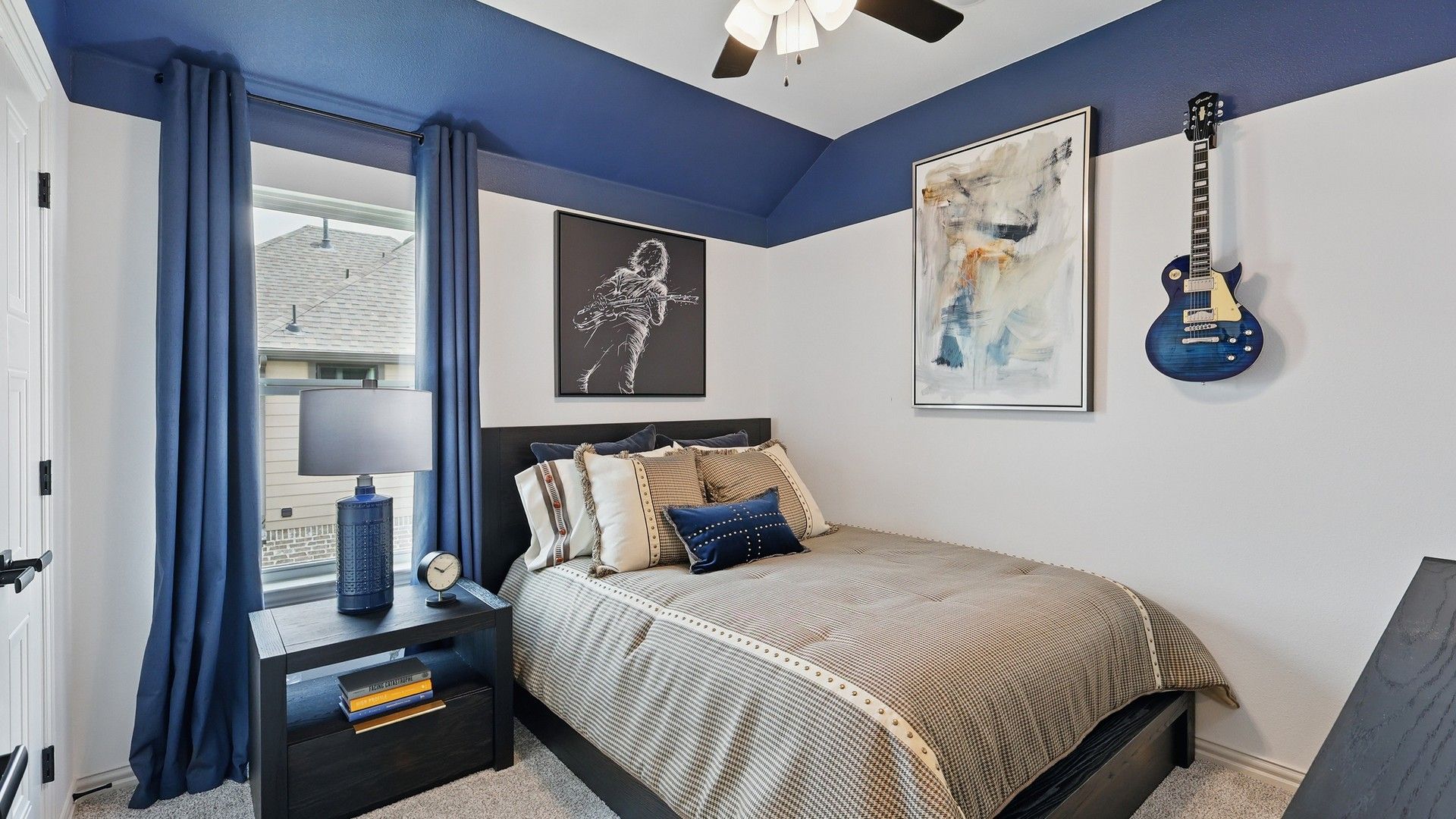 Westridge's bedroom boasts luxury with modern wall art and chic blue decor.