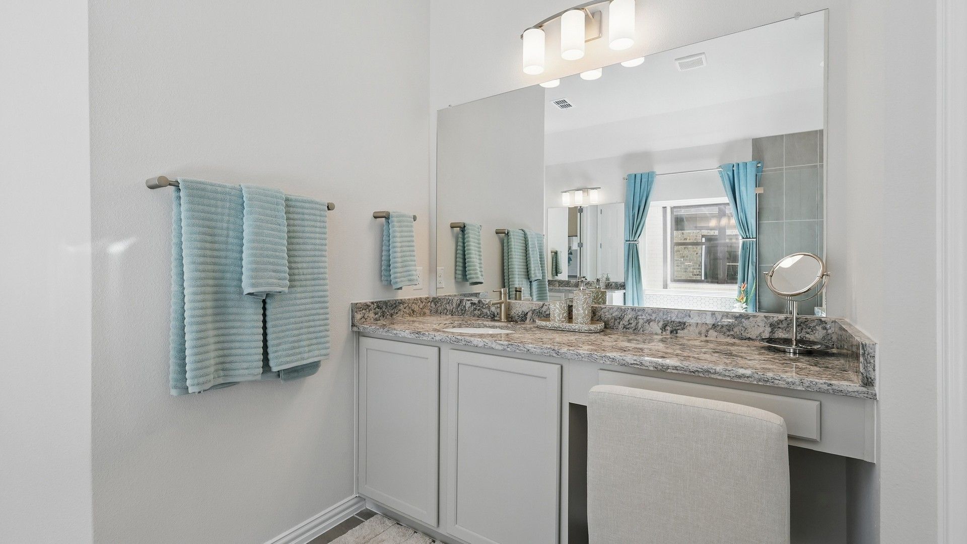 Experience luxury with a marble vanity, sleek light fixtures, and refined fittings in Green Oaks Preserve.