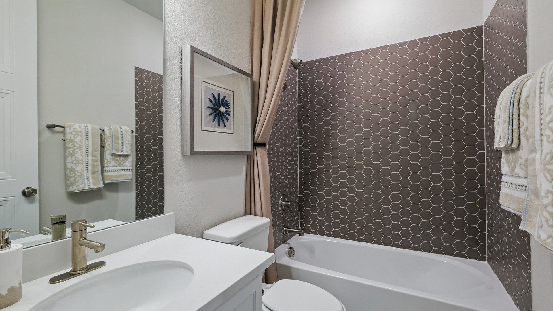 Features refined hexagonal tiling and premium fixtures, showcasing Green Oaks Preserve's luxury.