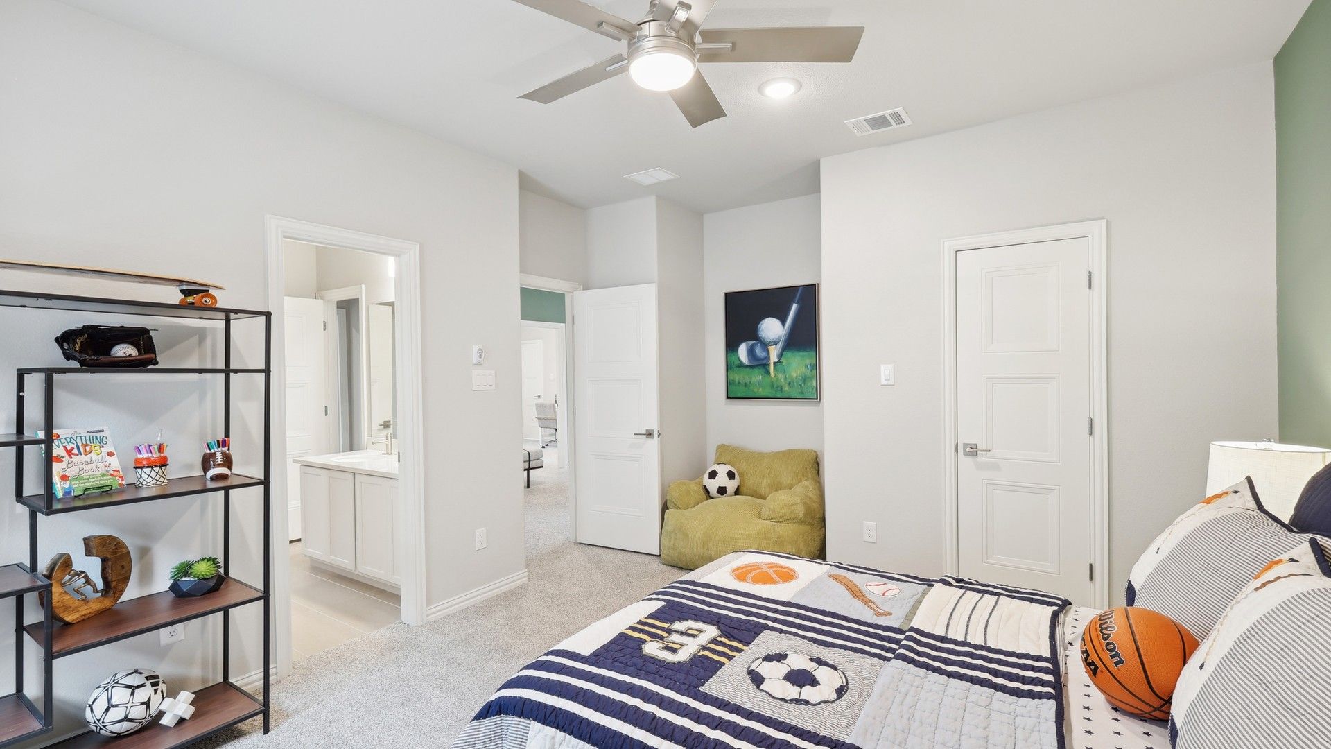 Elegant children's bedroom features luxury carpeting, chic ceiling fan, and modern ensuite in Wildflower Ranch.