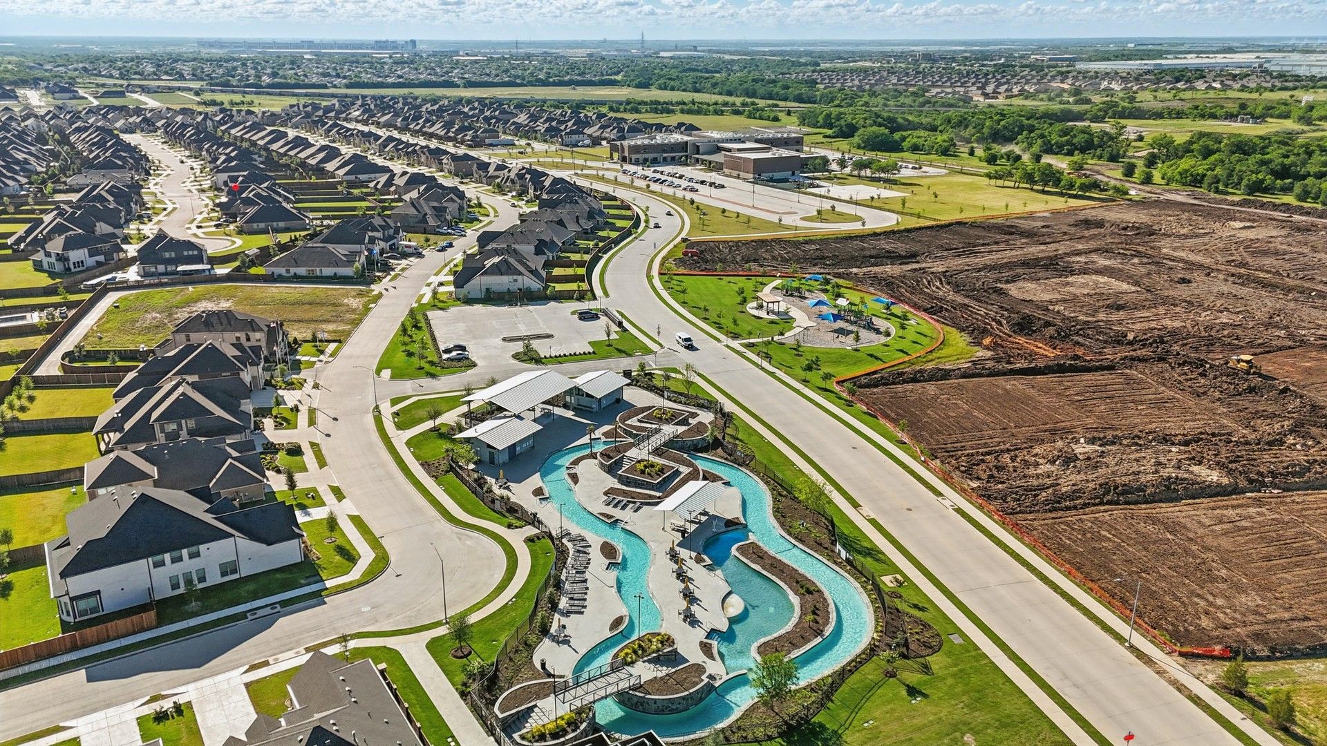 Elegant Wildflower Ranch showcases modern homes, a stylish pool, and verdant parks in peaceful Texas surroundings.