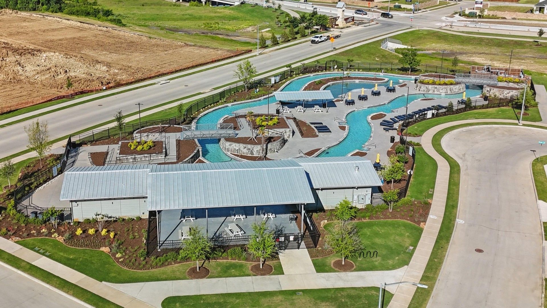 Discover Texas luxury at Wildflower Ranch, featuring a serene leisure pool with elegant pavilions and lush landscaping.