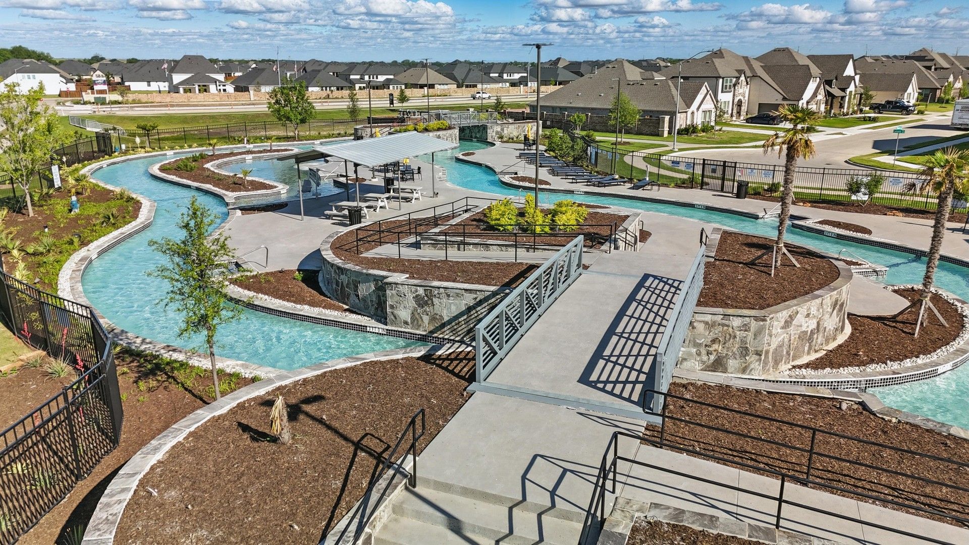 Experience luxury with a stone-lined lazy river, landscaped beauty, and modern architecture at Wildflower Ranch, Texas.
