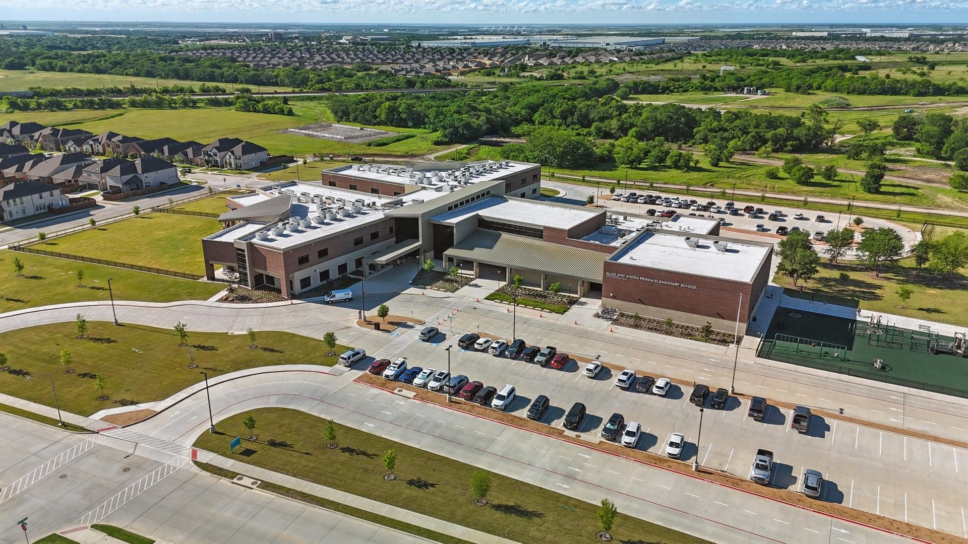 Elegant school design with sleek lines and expansive green spaces in Wildflower Ranch.