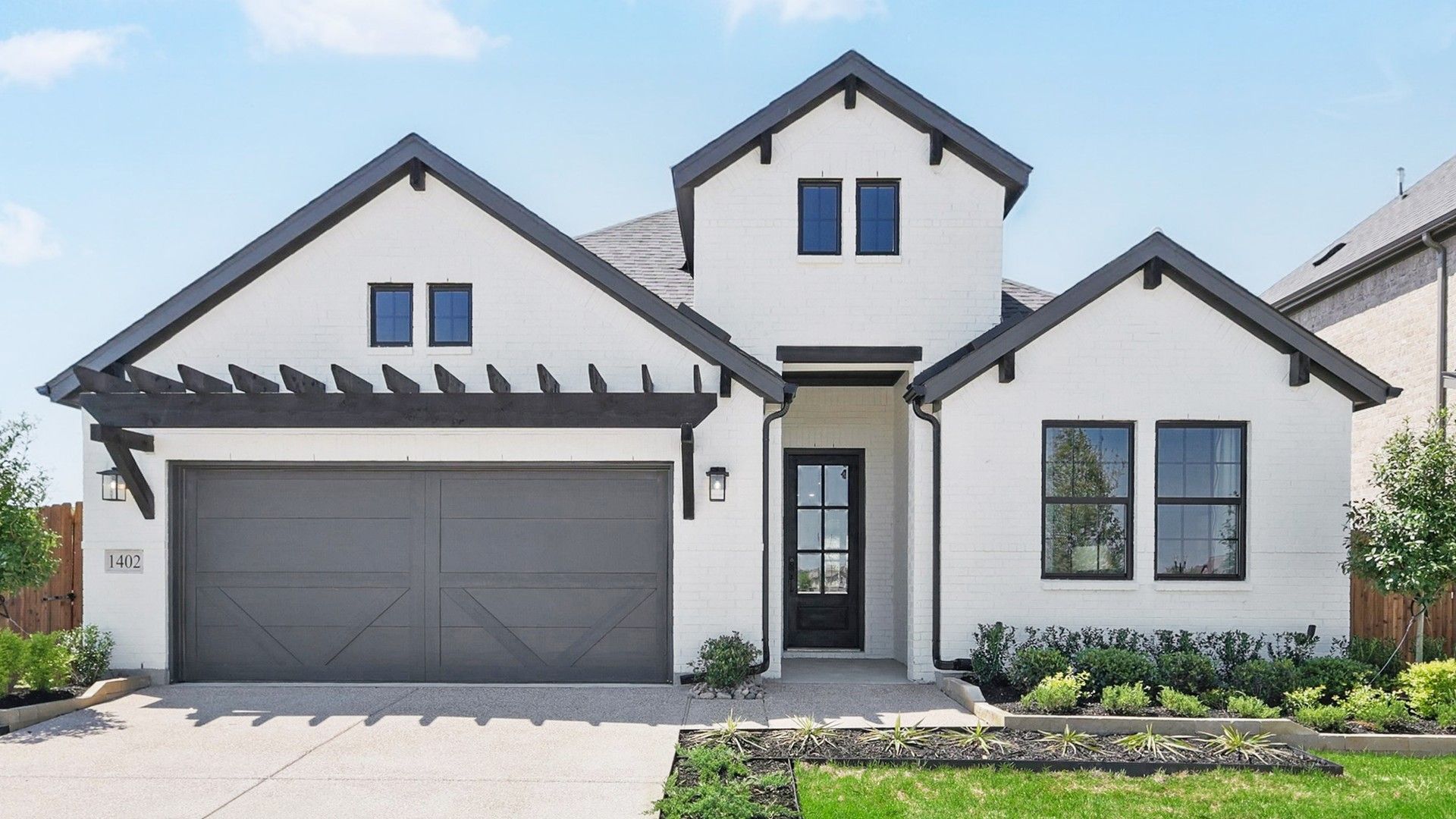 Elegant gabled facade with striking black accents in Green Oaks Preserve.
