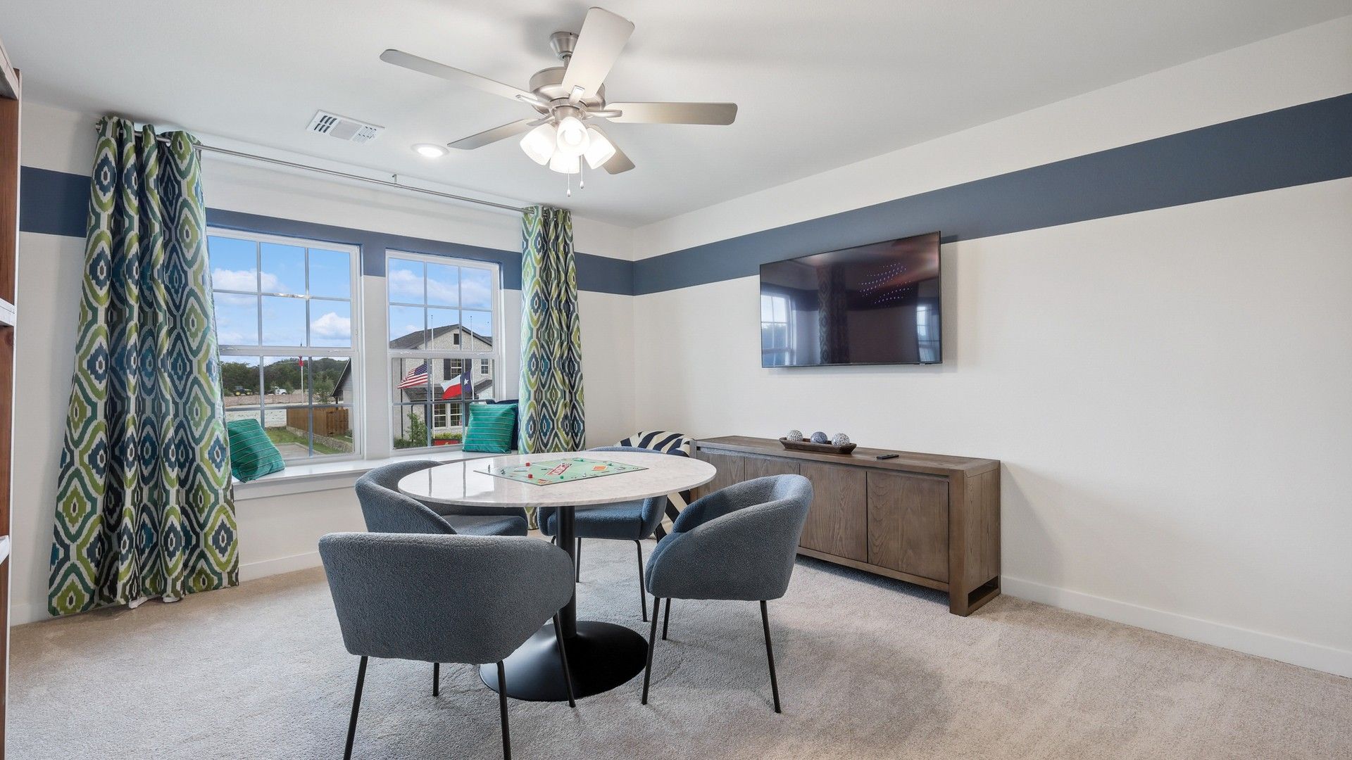 Luxurious living space with large windows boasts plush furnishings and stylish modern design in Churchill community.