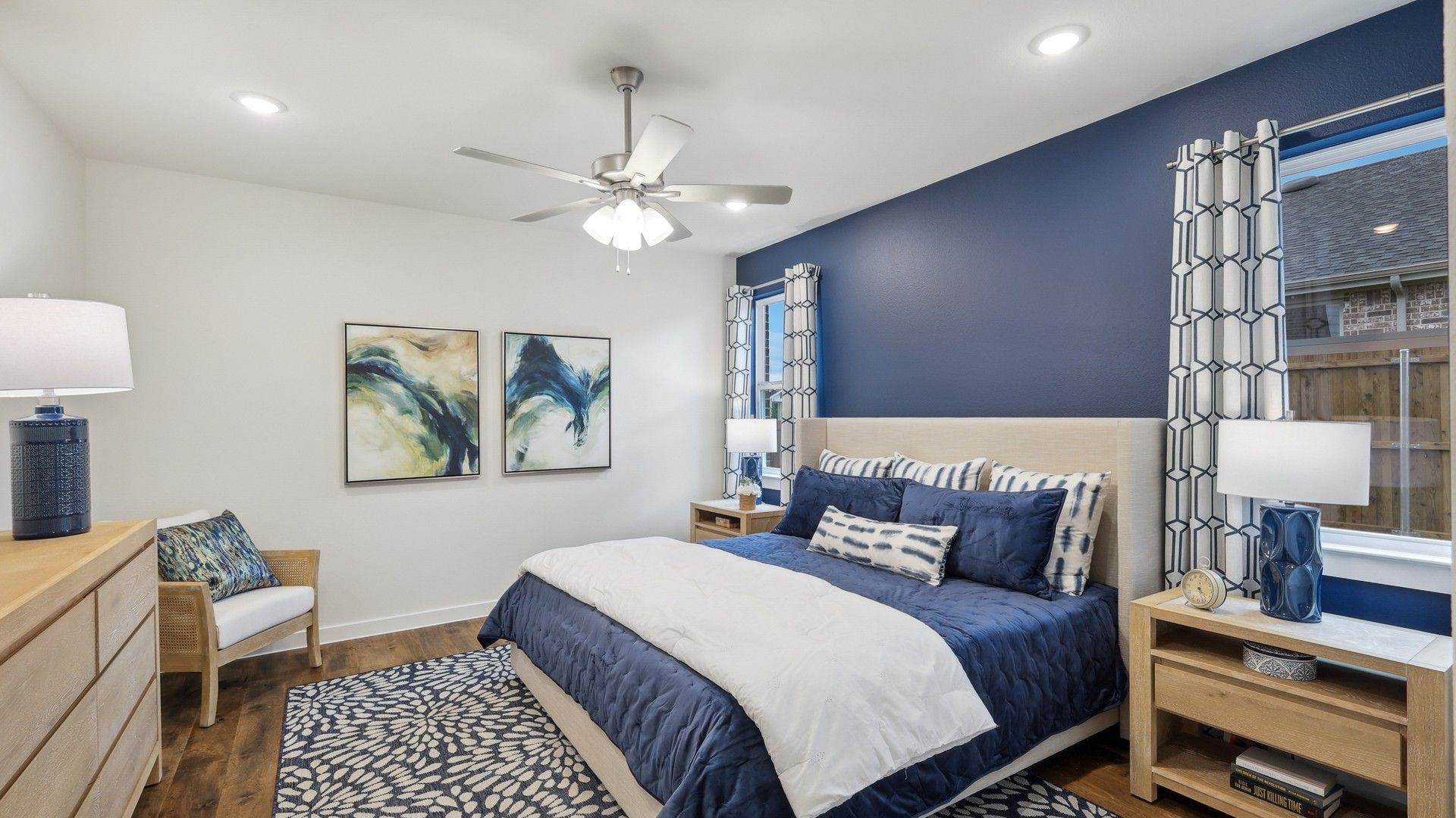 Luxurious Churchill bedroom with refined blue accents, modern furnishings, and rich wooden flooring.