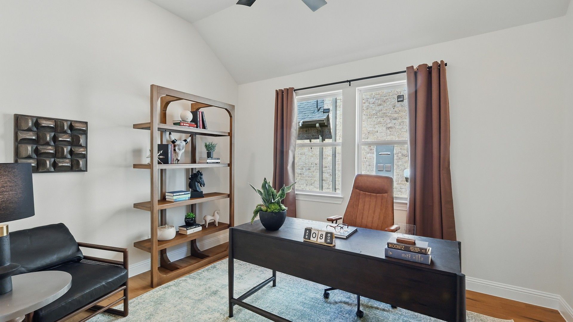 Luxurious office with vaulted ceiling and oak flooring, blending elegance and functionality in Green Oaks Preserve.