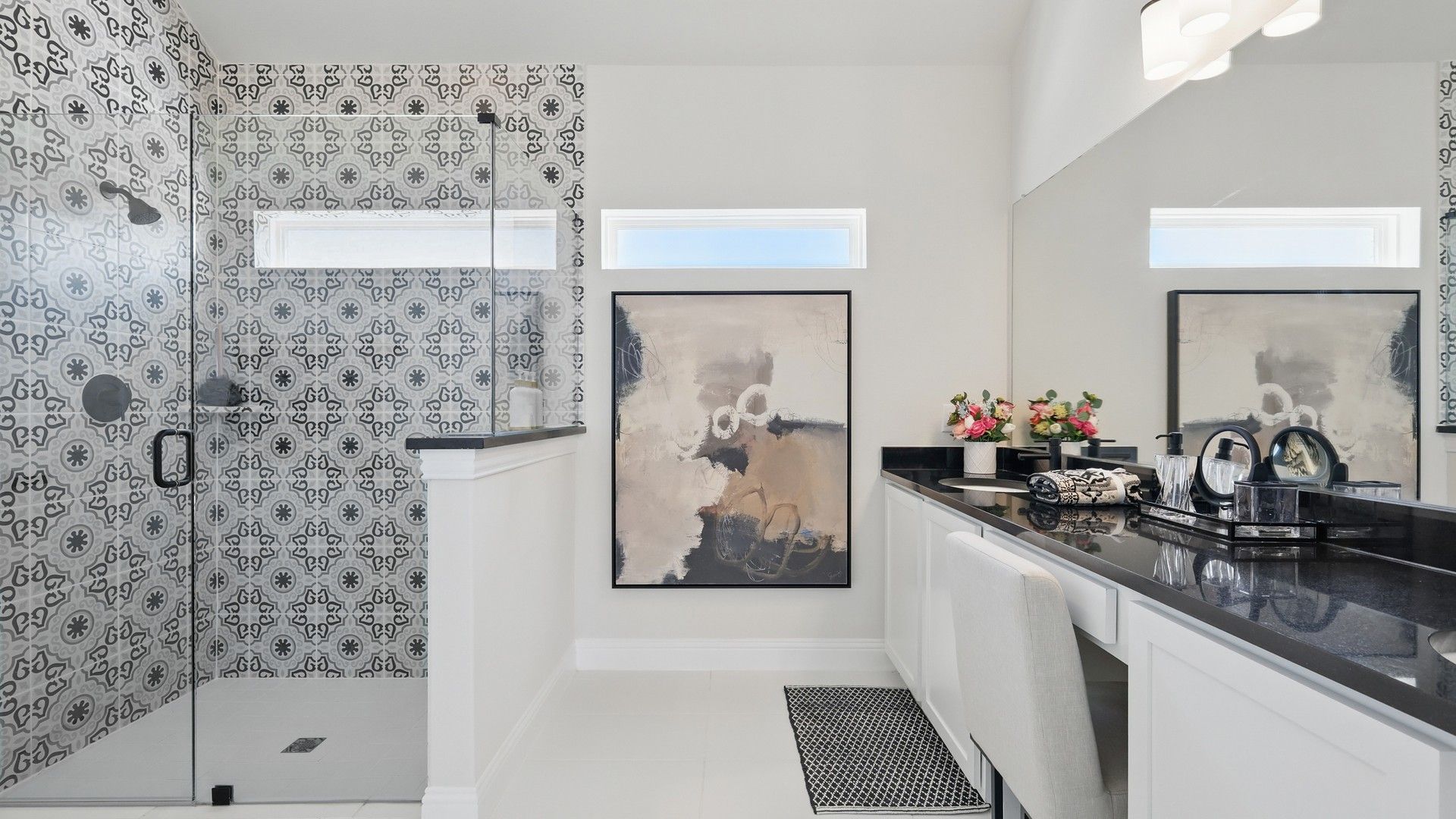 Experience sophistication with patterned tile shower and sleek counters in Green Oaks Preserve's exquisite bathroom.