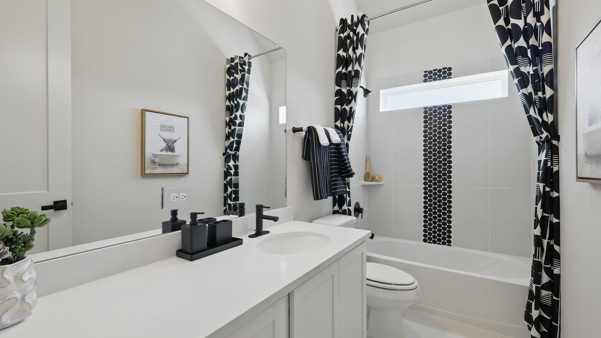 Contemporary design with luxury black hardware, geometric patterns, and sleek lines in Green Oaks Preserve.
