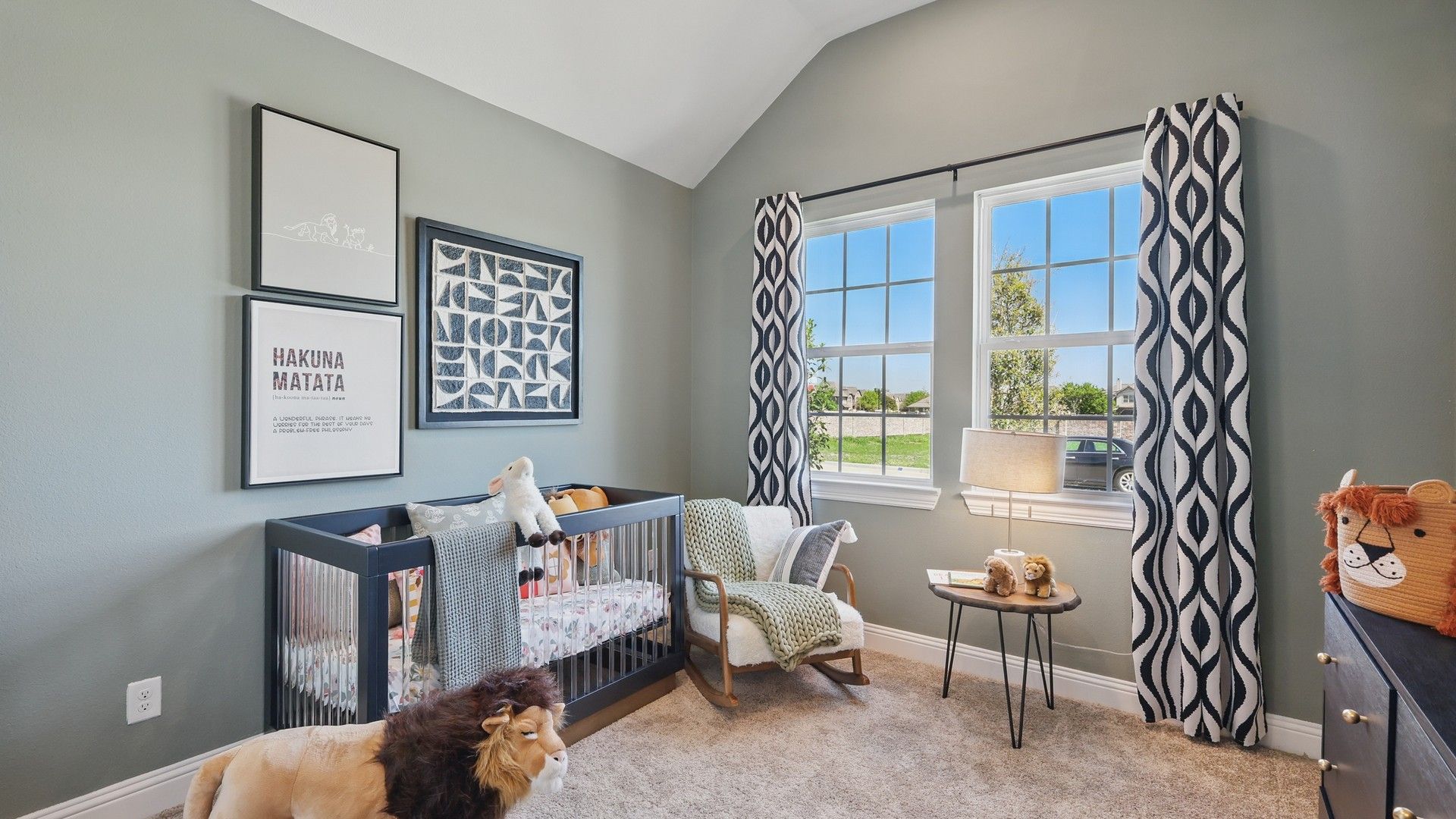 Exquisite nursery with elegant artwork, plush carpet, and expansive windows in Green Oaks Preserve.