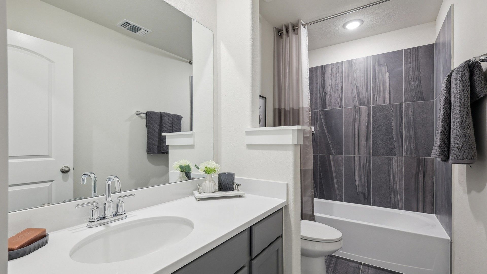 Experience luxury with sleek black tiles, elegant fixtures, and refined detailing in Churchill community.