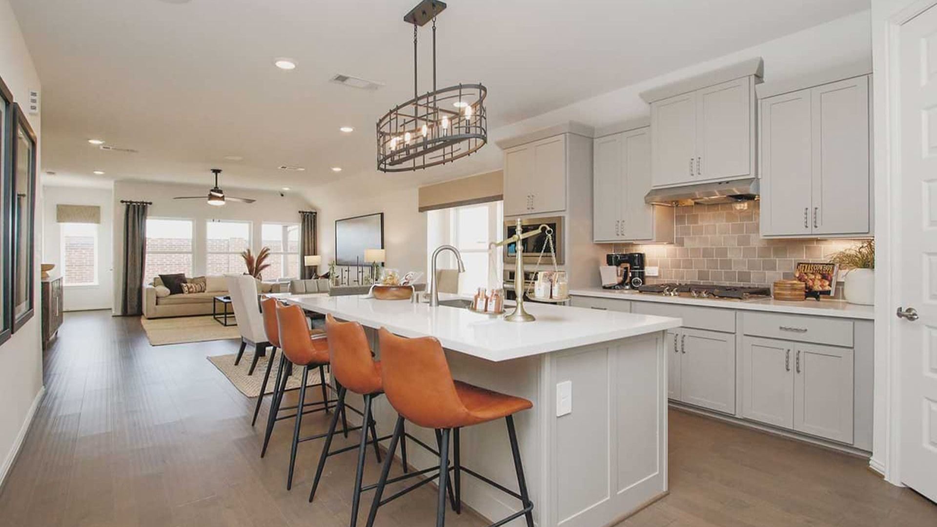 Elegant quartz countertops and bespoke cabinetry elevate this Cypress Green culinary space.