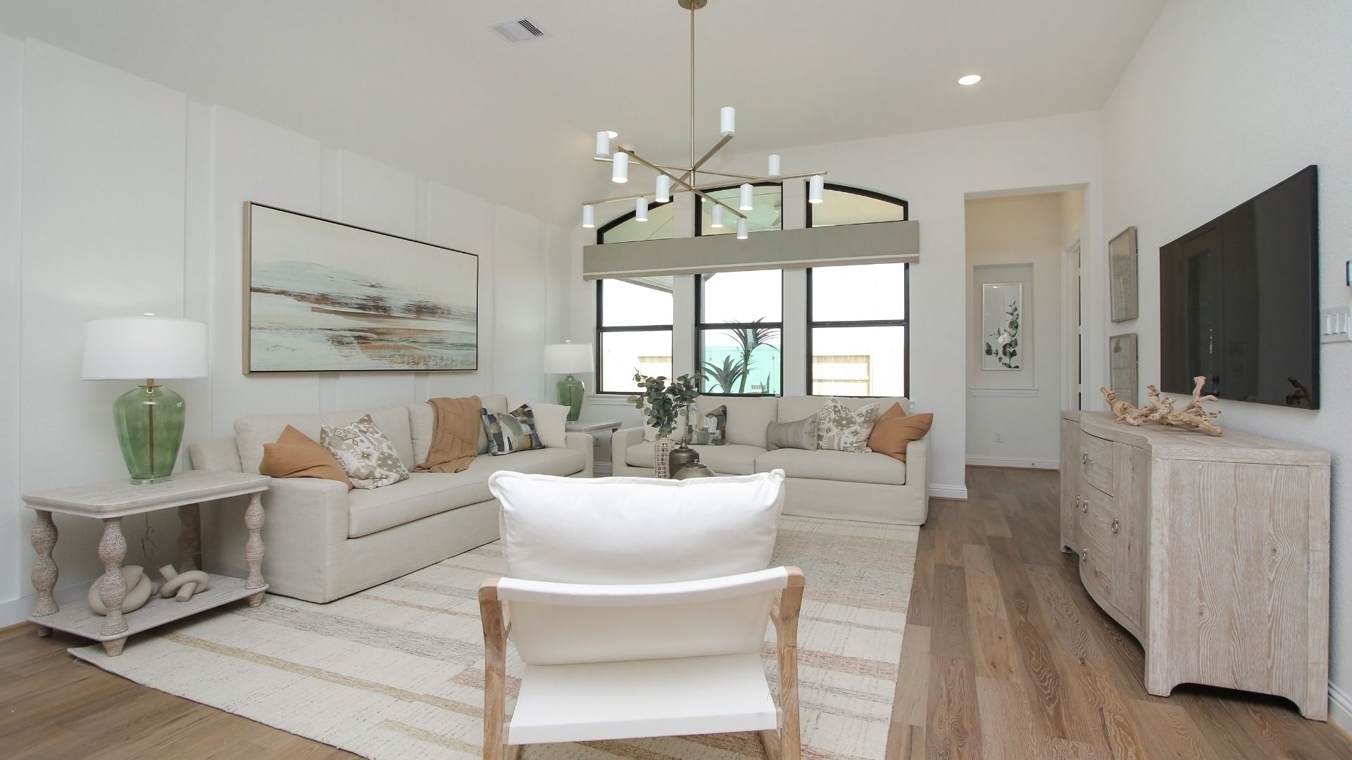 Elegant chandeliers and large windows define this refined Sunterra masterpiece.