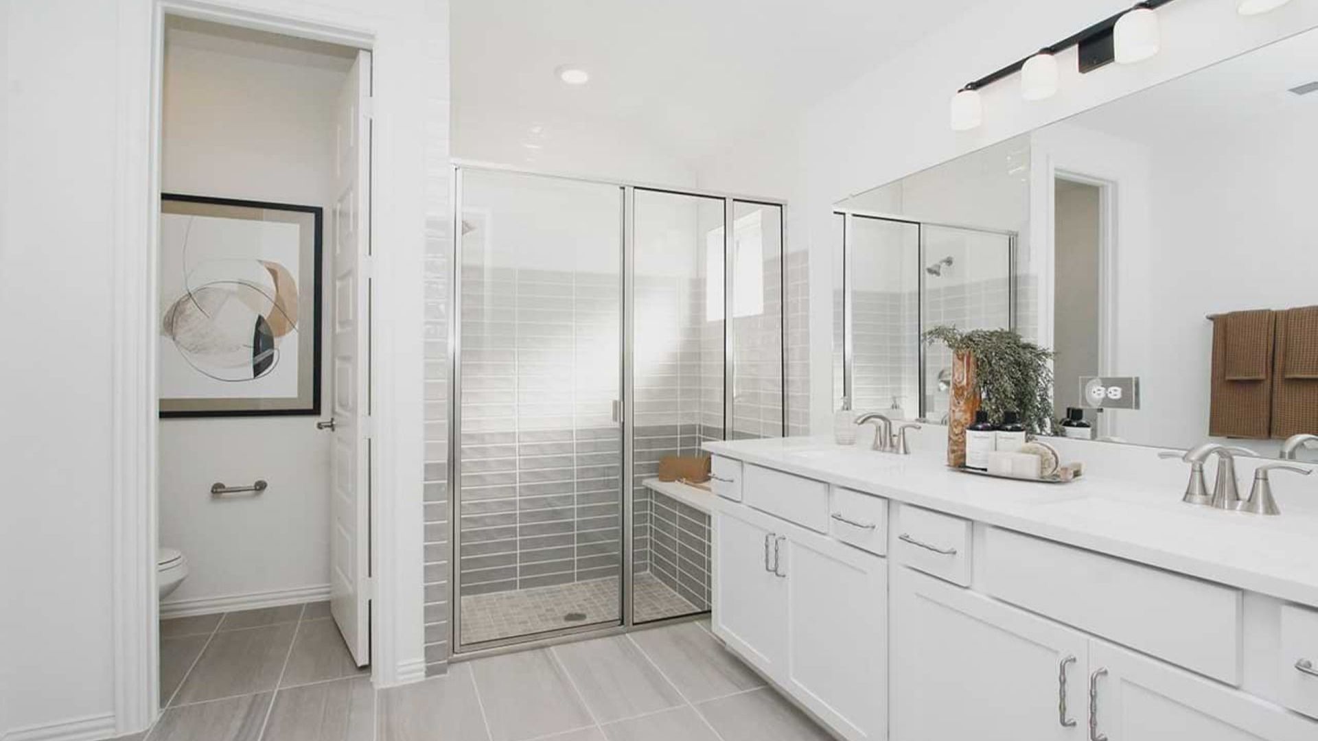 Luxurious bathroom in Cypress Green features sleek dual sinks and elegant glass shower enclosure.