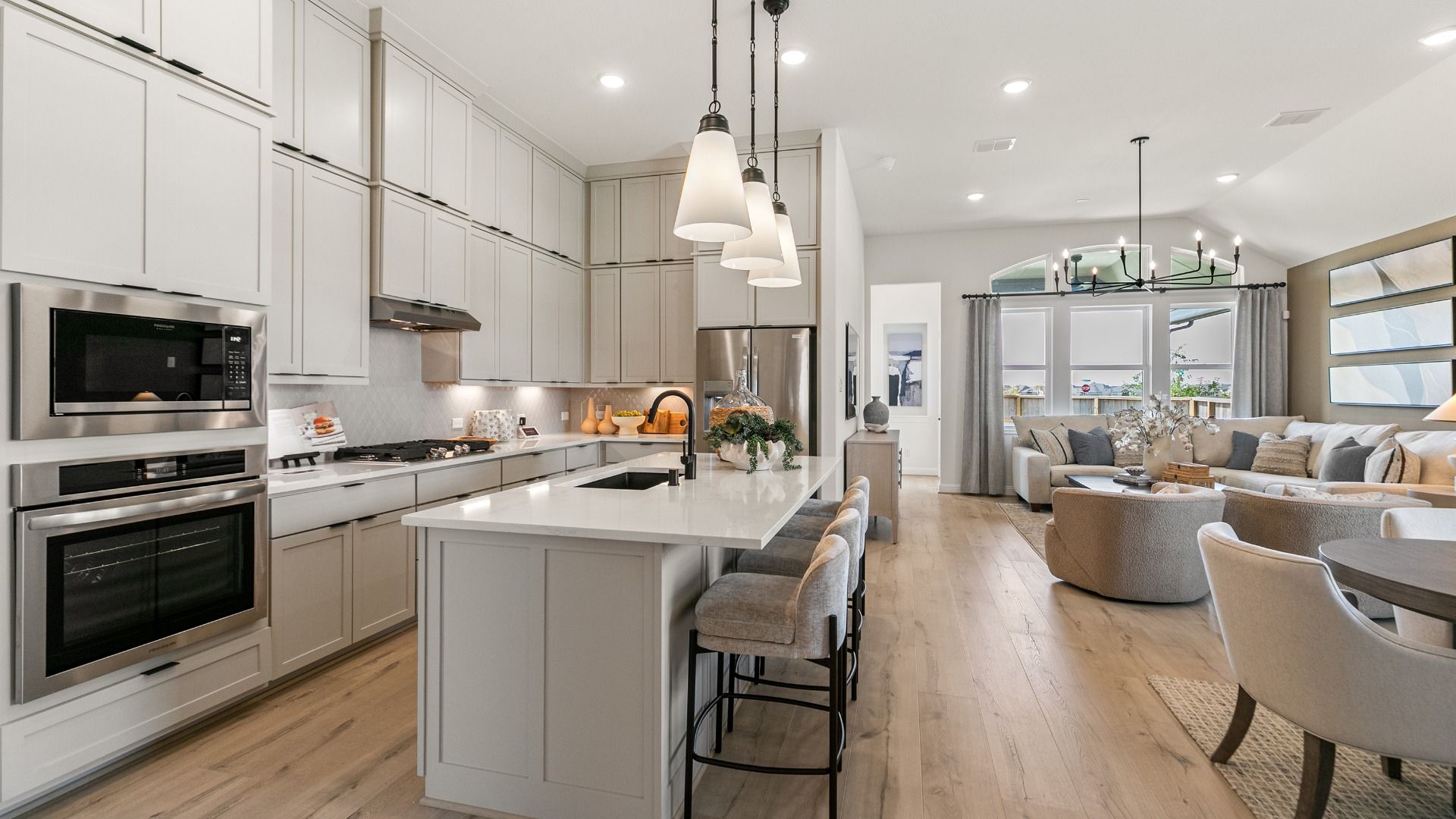 Oversized island serves as the centerpiece of the kitchen, providing generous prep space and a natural place to gather.