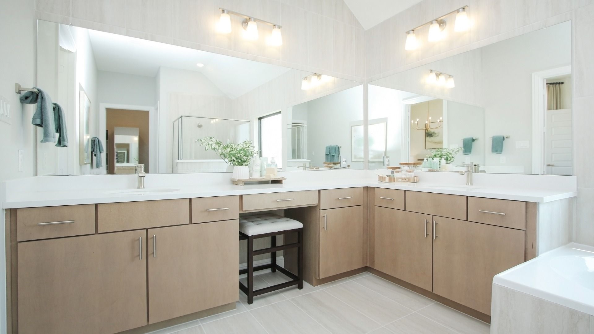 Experience refined elegance with light wood cabinetry and expansive mirrors in Sunterra's serene oasis.