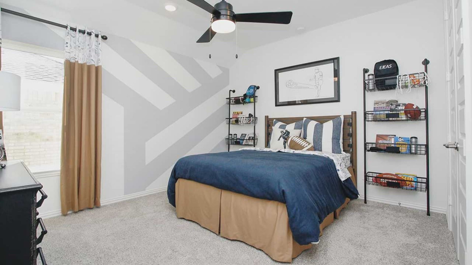 Discover refined comfort in this Cypress Green bedroom with a chic geometric wall and upscale sports accents.