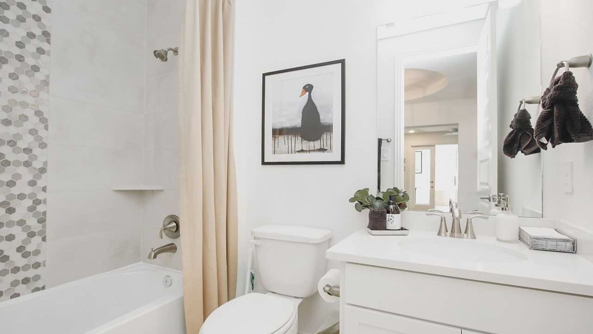 Luxurious bathroom features chic hexagonal tiles and premium fixtures in the Cypress Green community.