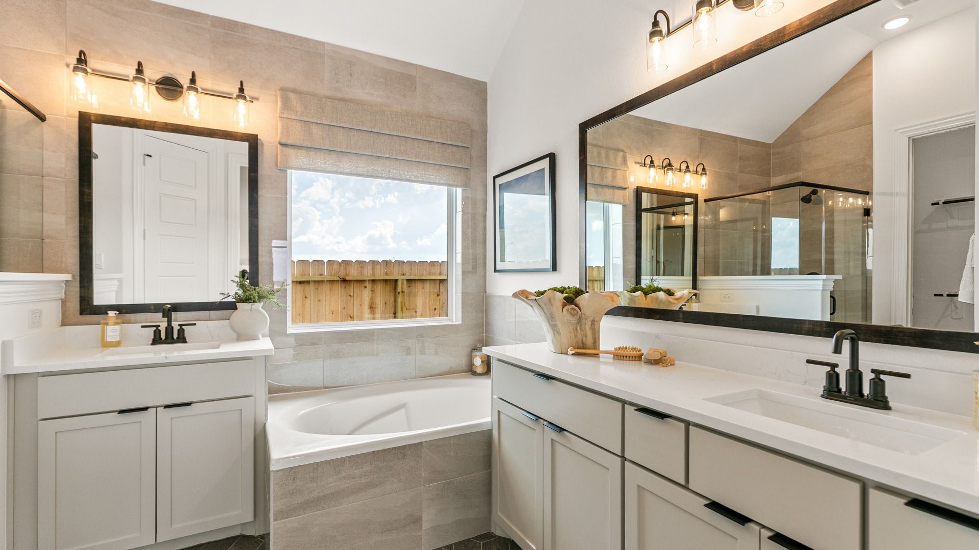 A luxury primary bathroom featuring dual vanities and a relaxing soaking tub for a spa-like experience.