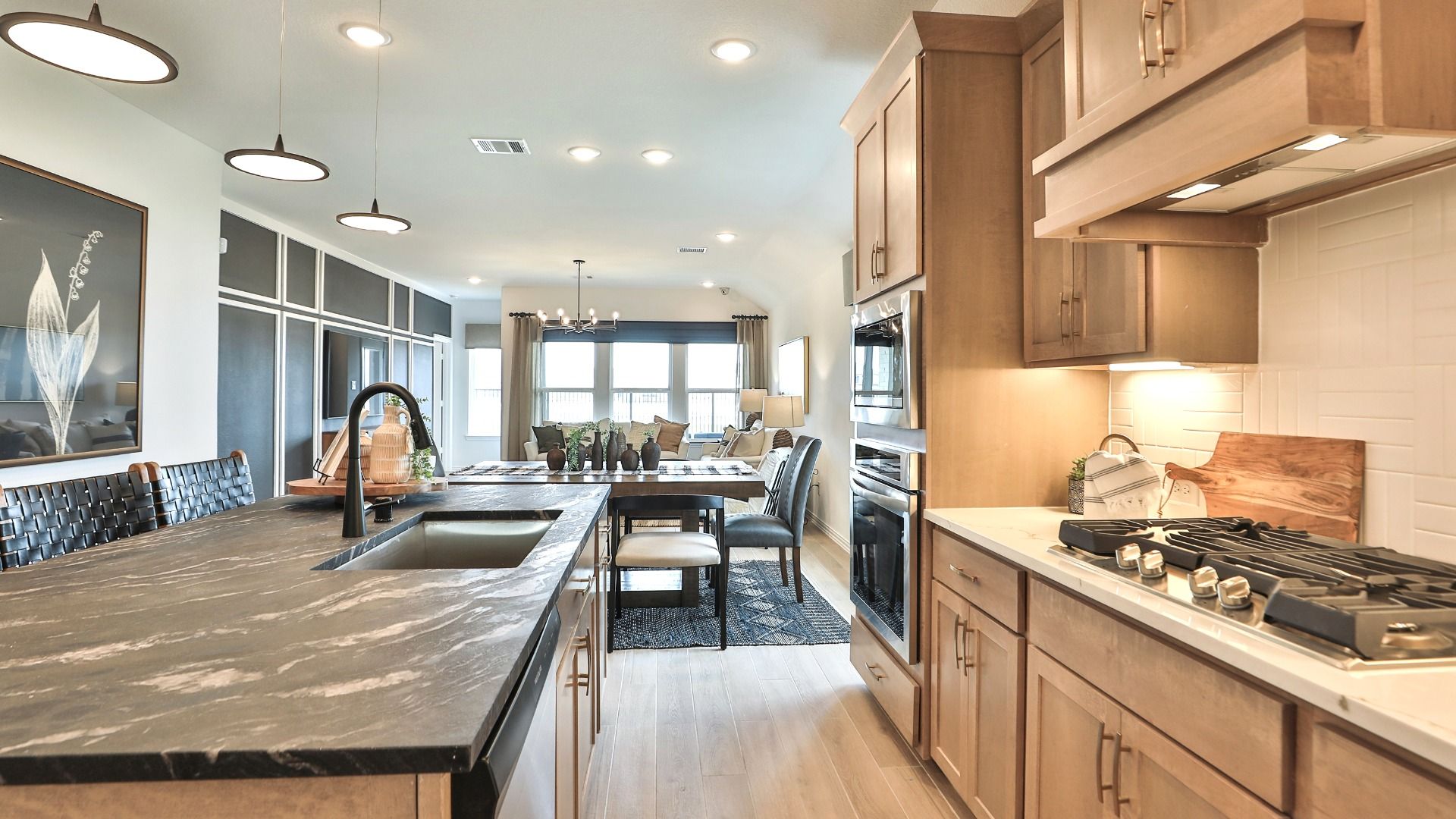 Luxurious marble island, elegant wood cabinetry, and premium stainless appliances in Bridgeland's upscale kitchen.