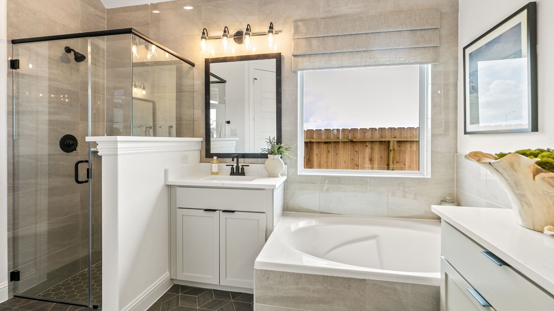 A spa-inspired primary bathroom featuring a large glass walk-in shower for a sleek, modern feel.