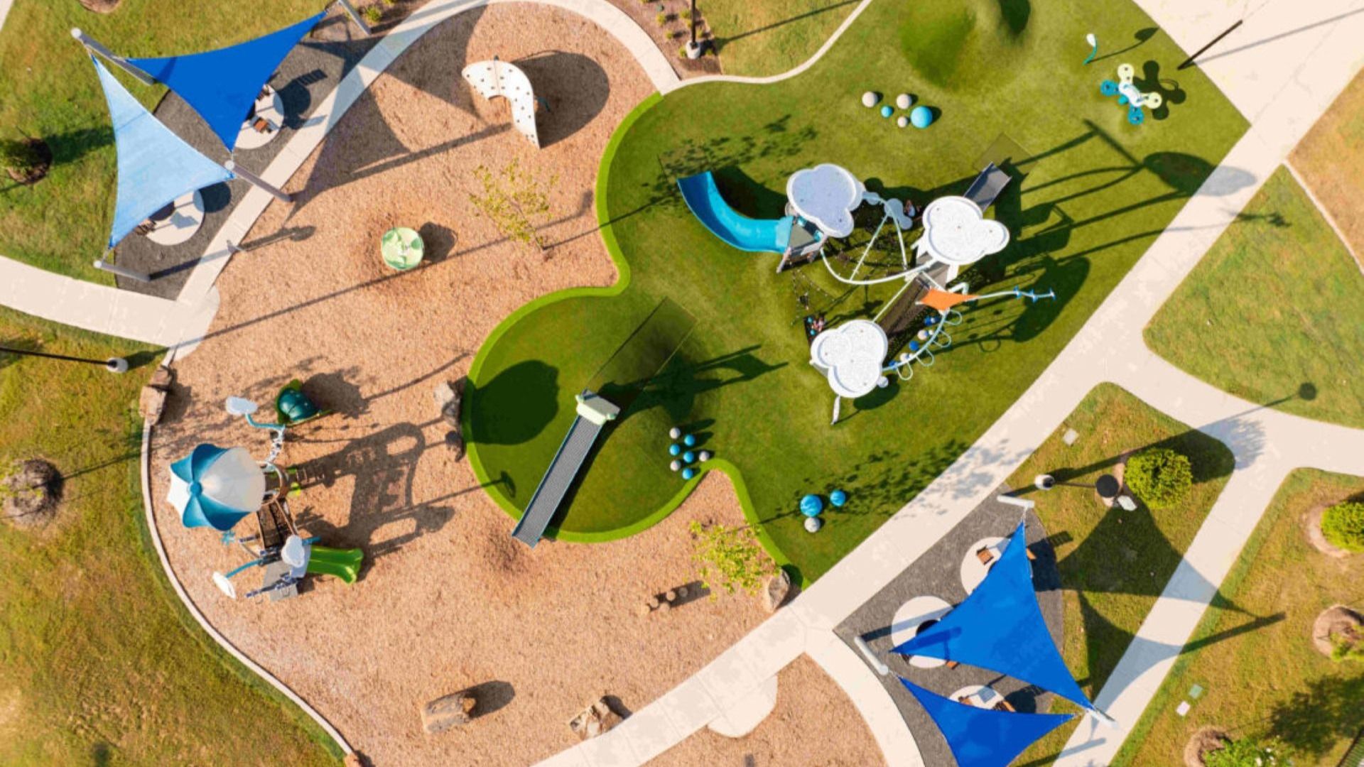 Experience innovative design with modern play structures and striking blue sails in Sunterra community.