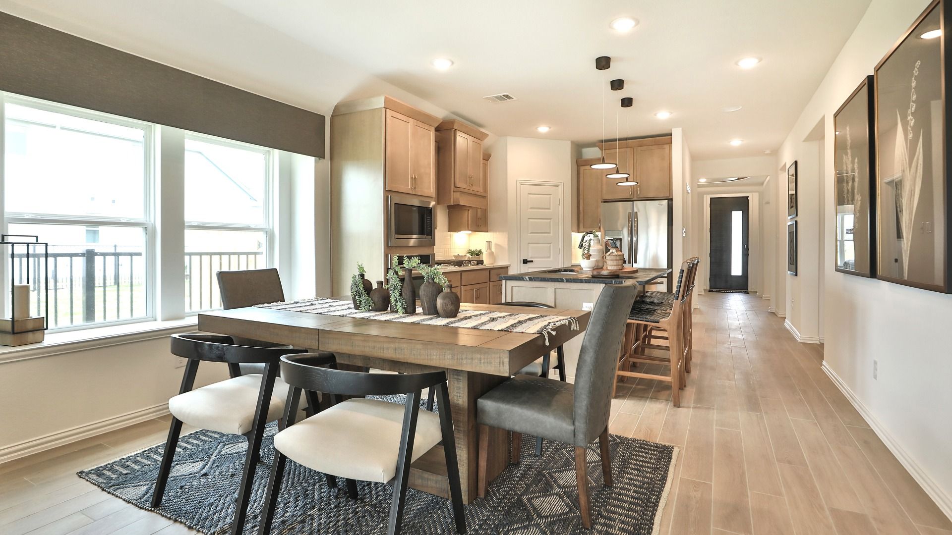 Elegant wood cabinetry and flooring highlight this Bridgeland home's open-plan dining and kitchen area.